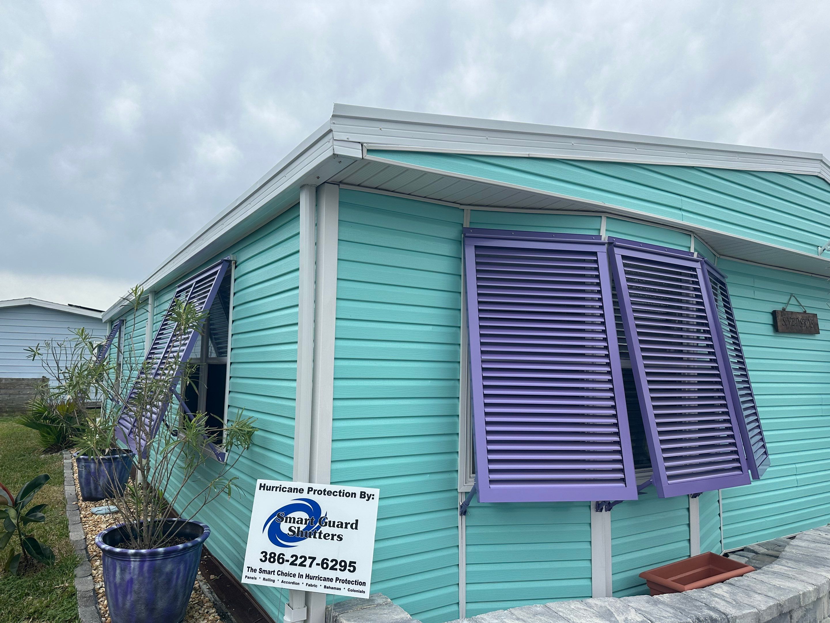 Hurricane Rated Bahama Shutters in Pearl Violet by Smart Guard Shutters