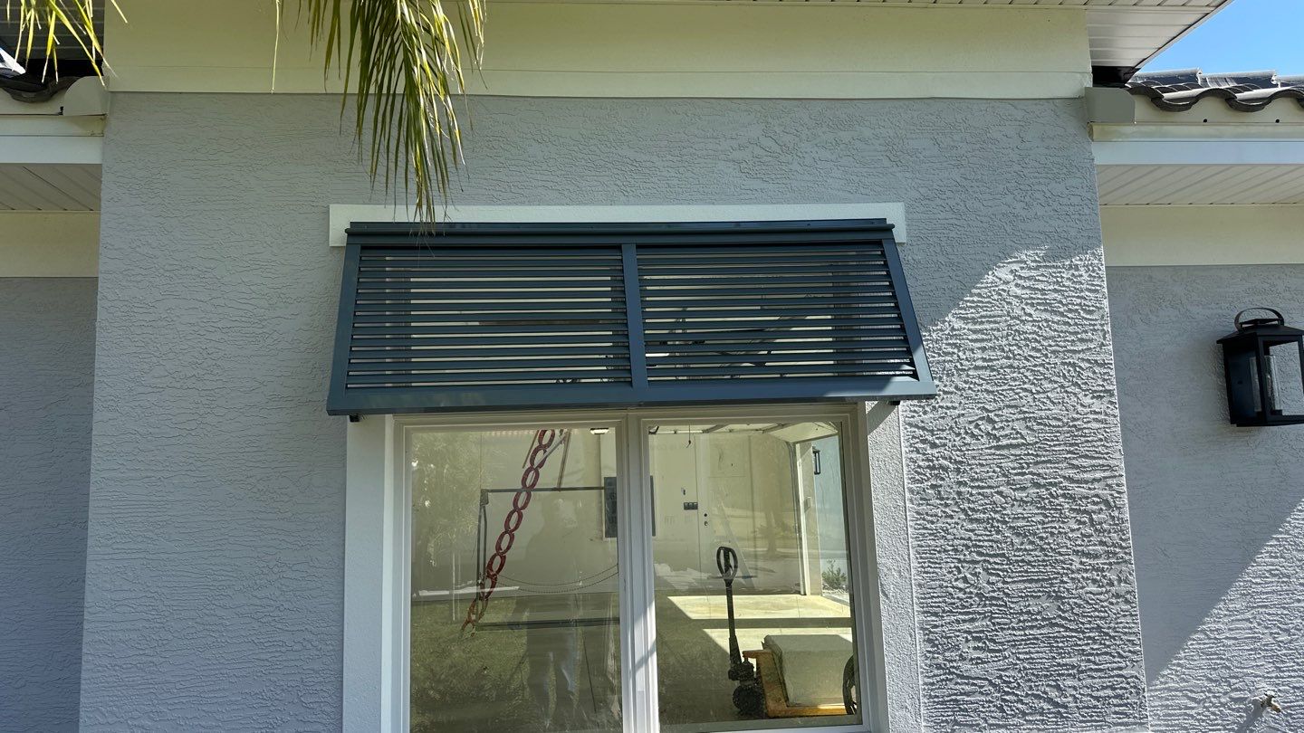 Bahama Shutters in Blue Grey by Smart Guard Shutters