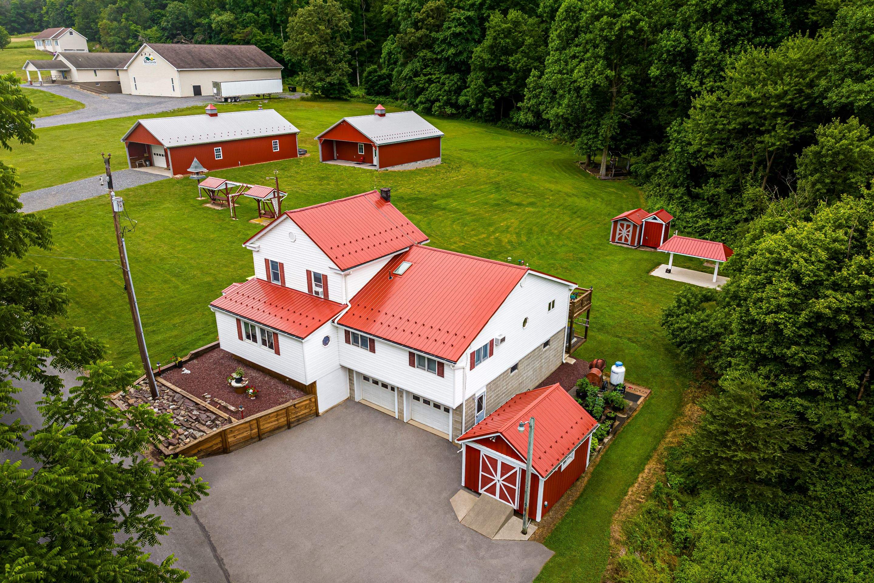 Metal roof -barn red, and New garage by Esh Builders