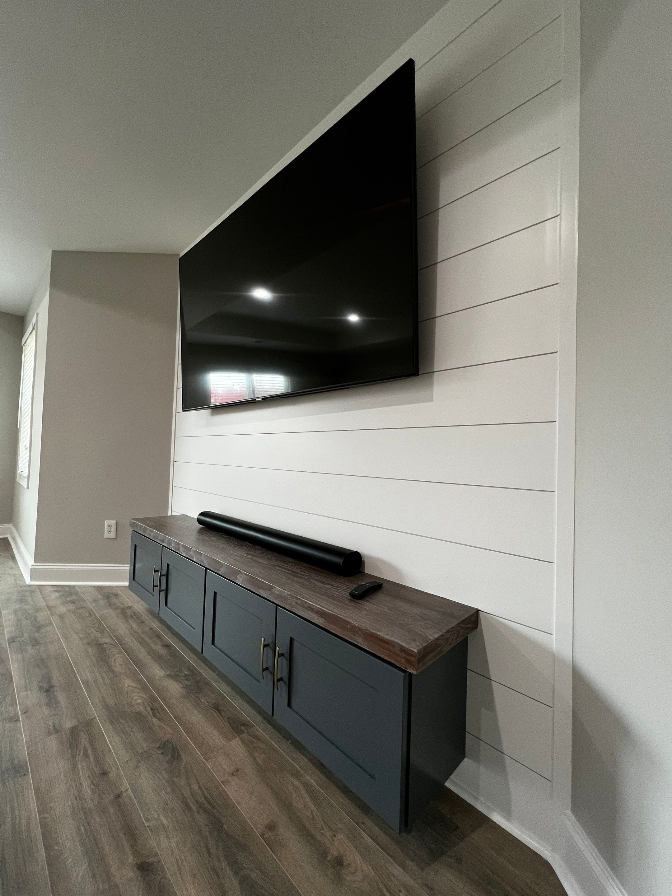 Modern Basement Remodeling in Woodstock with Custom Live-Edge Bar by Swift Home Renovations