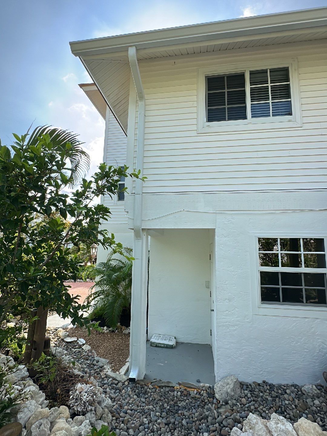 White K-Style Gutters Installed with White Downspouts in Sanibel FL by Gutter Professors