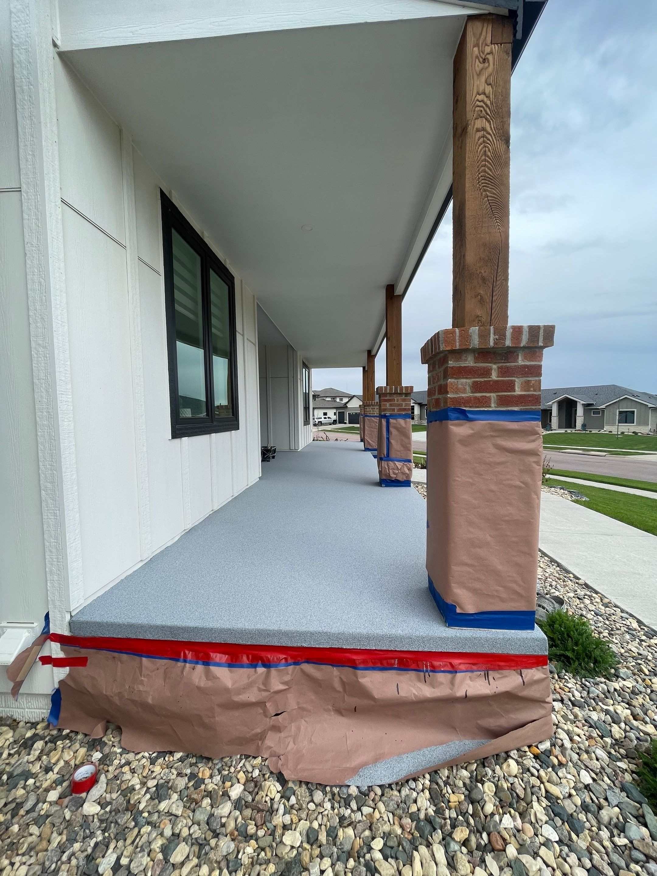 Grey Speckled Concrete Porch Coating for Sioux Falls Home by Select Painting, Coatings & Garage Cabinets