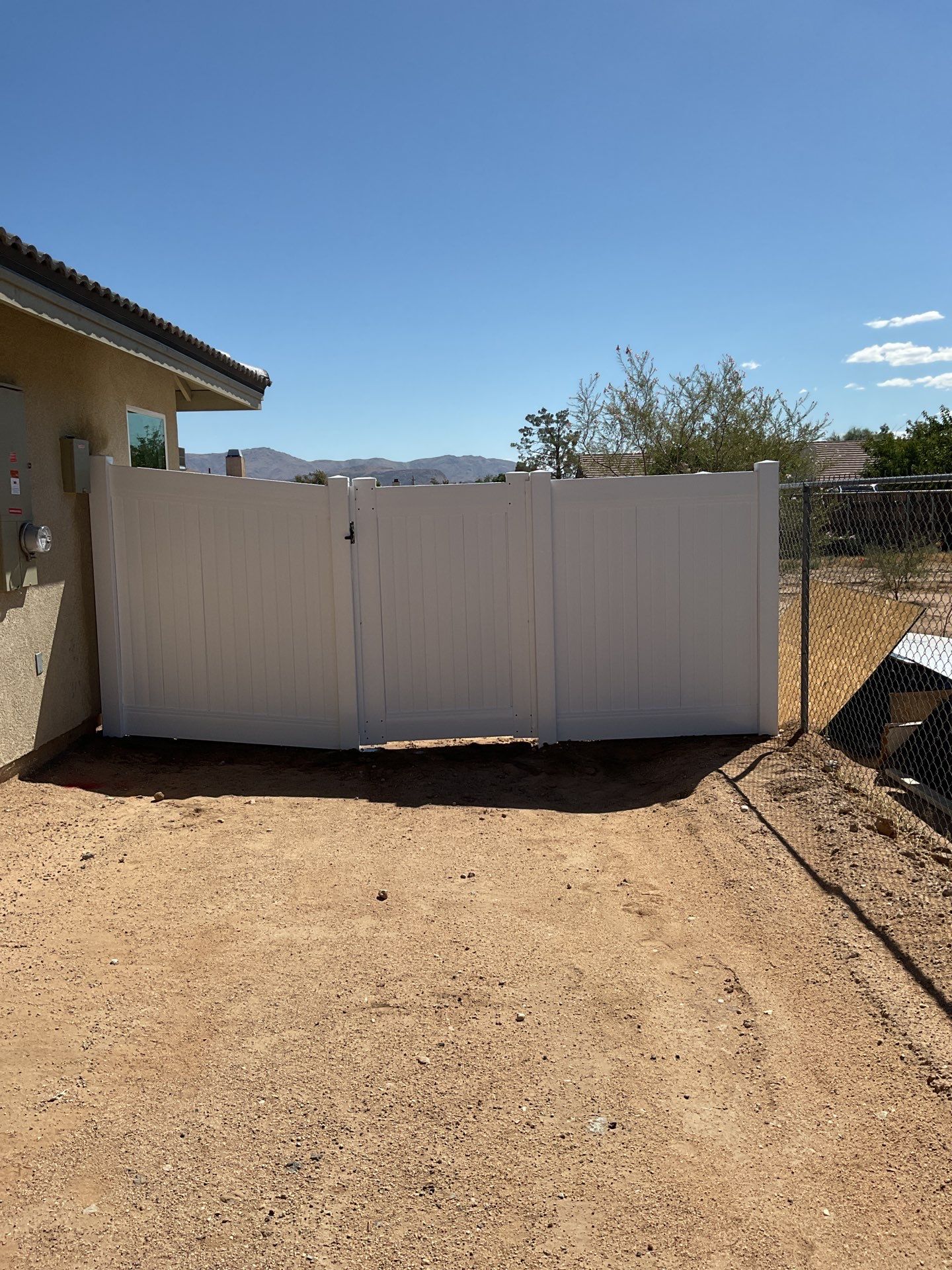 6ft White Privacy Vinyl Fence with Chain-link Fence by Fence Guys Inc.