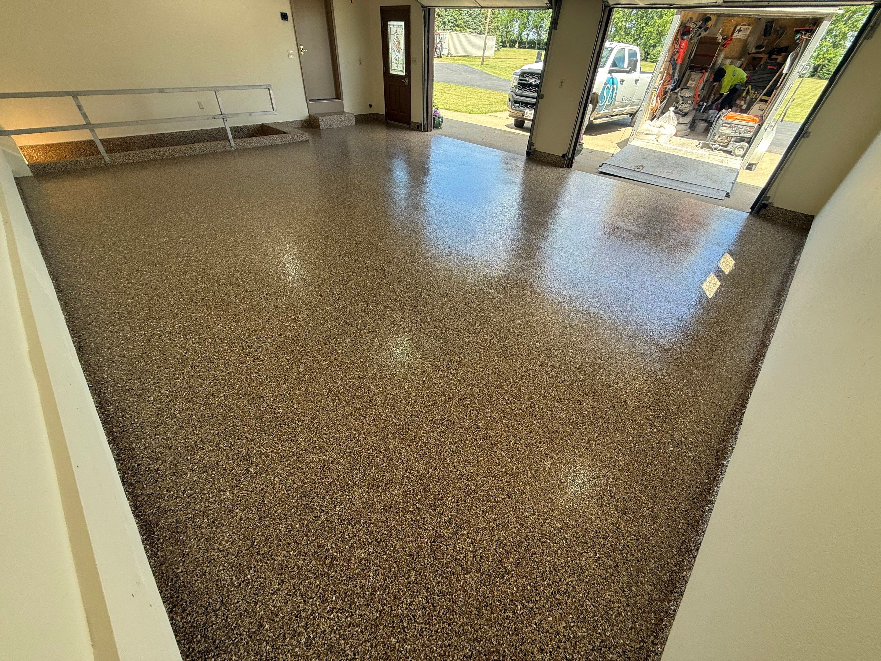 Custom Polyaspartic Garage Floor and Stairwell Coating in Pipestone by Select Painting, Coatings & Garage Cabinets