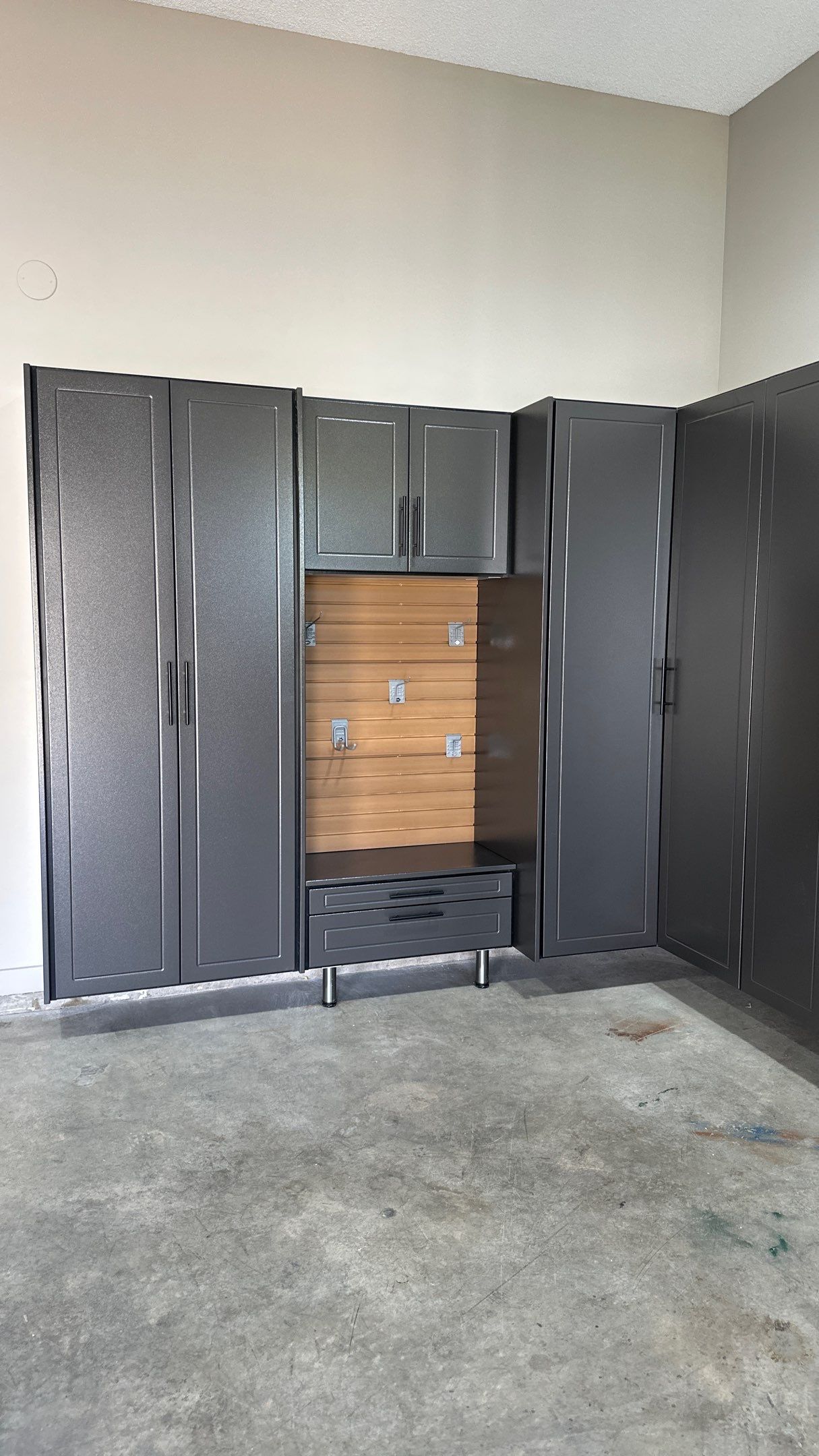 Mark S. chose Global Pine slotwall with his Pewter cabinets.  by Banner Garage