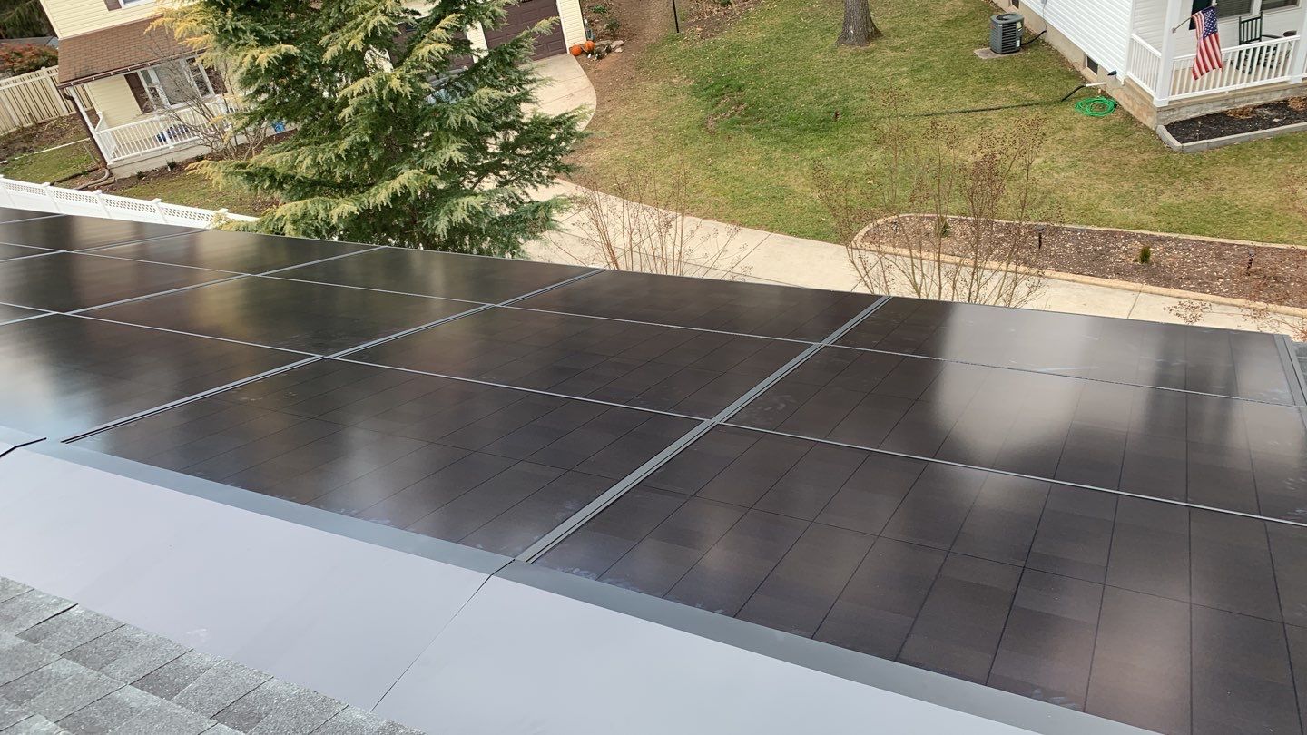Roof Replacement with GAF Decotech integrated solar panels by American Home Contractors