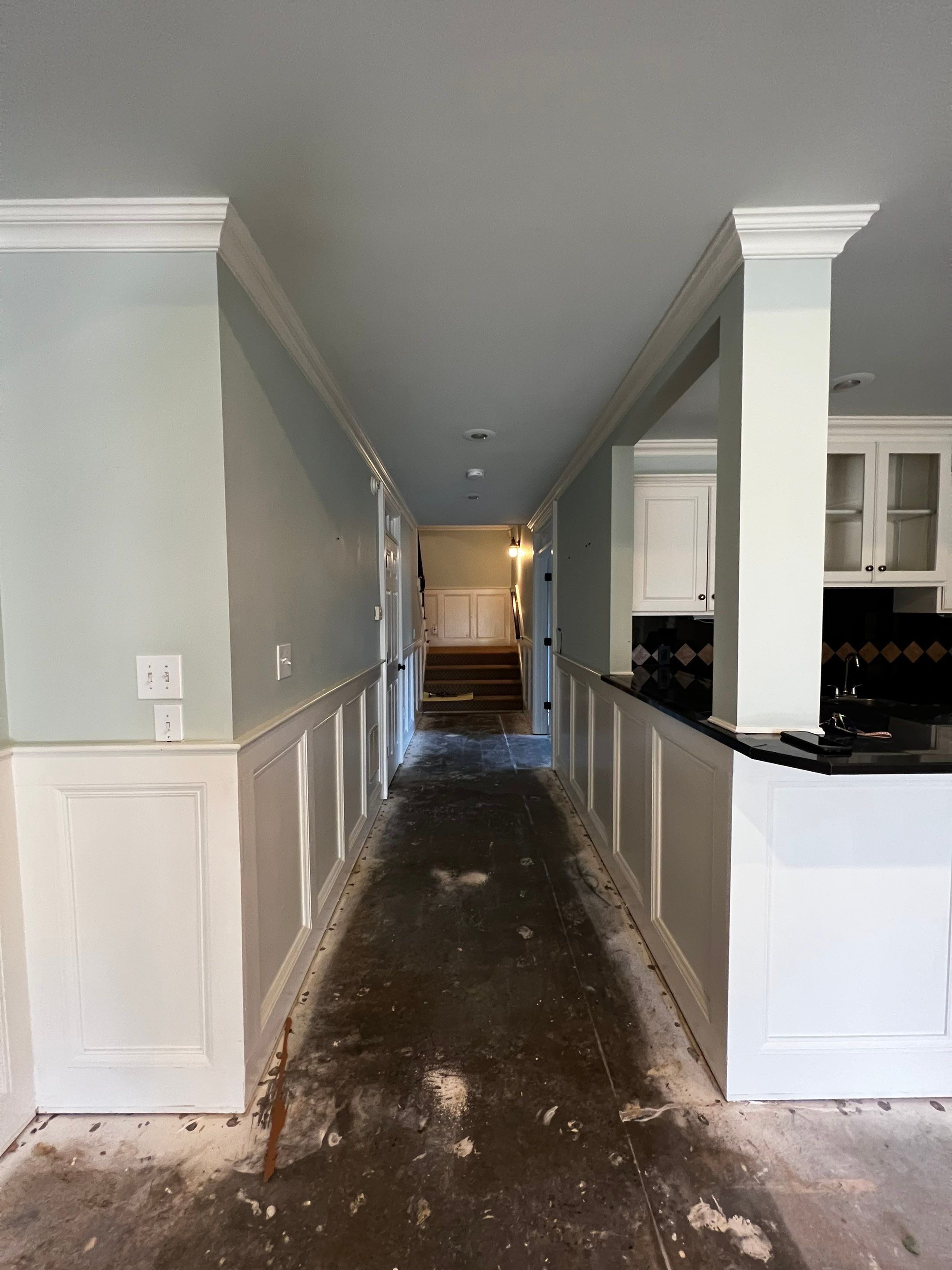 Finished Basement Remodeling with Dark Wood-Look Flooring and Custom Wainscoting by Swift Home Renovations 