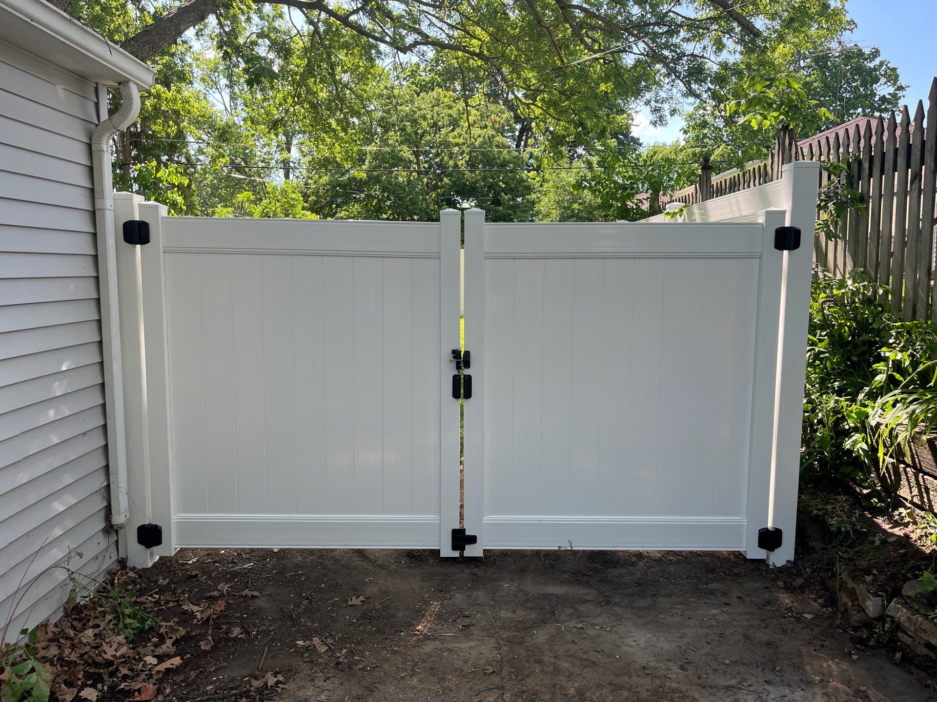 White Vinyl Privacy Fence and Double Gate Installation in Cedar Falls by Perfect Picket Fence and Stain