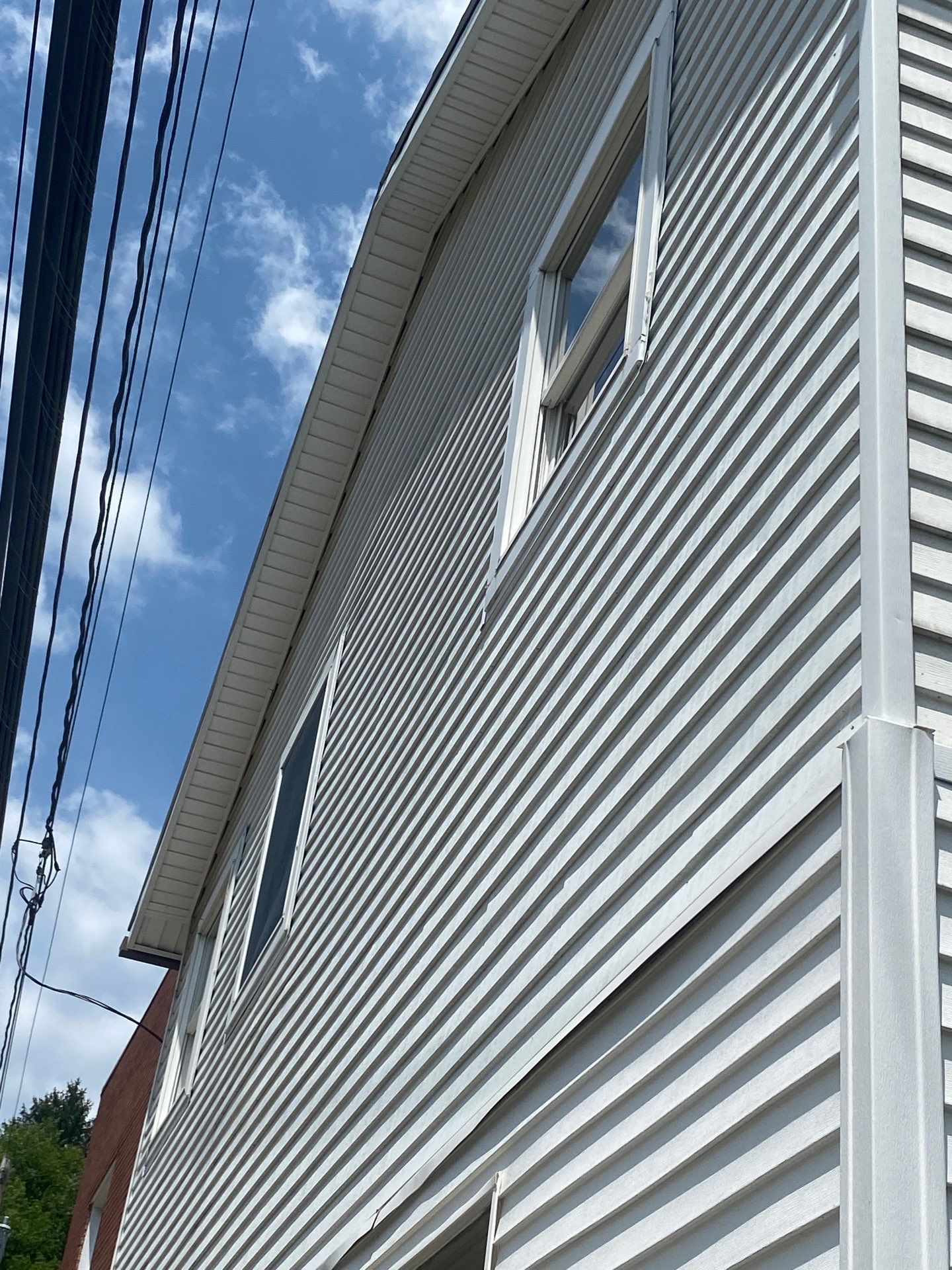 White siding  by Cousins Roofing Siding & Decks
