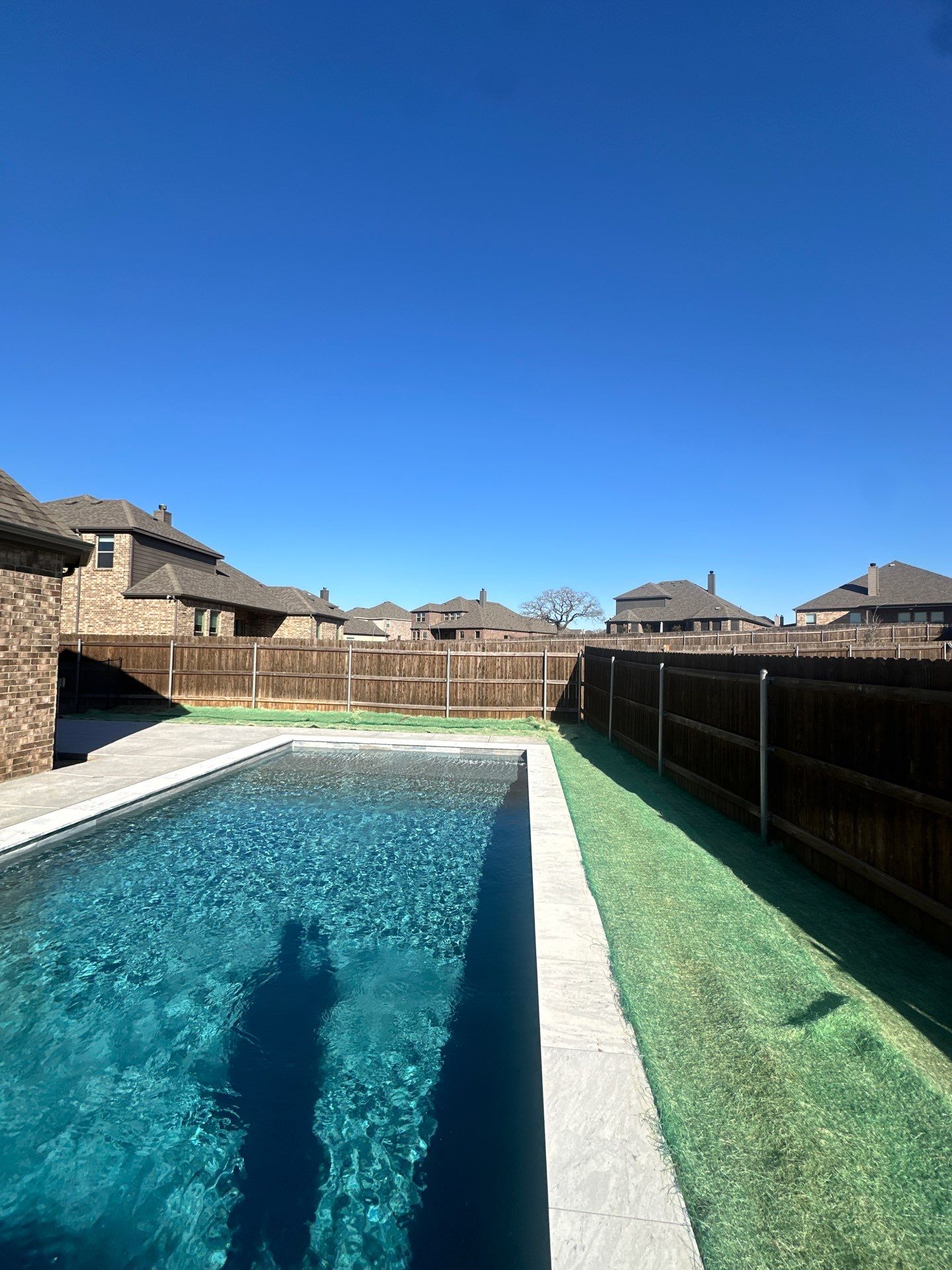 Modern Lap Pool with Turf Surround by Pinnacle Pools and Spas - DFW