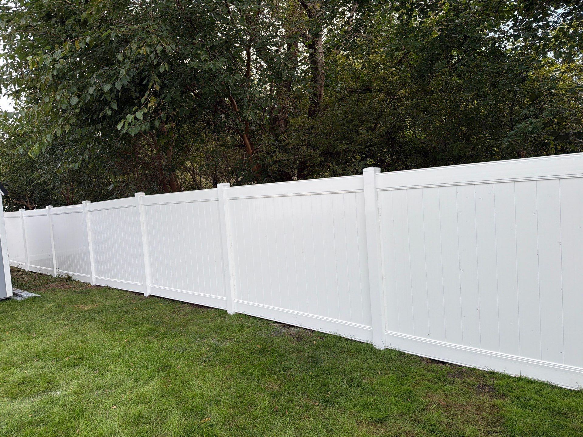 White Vinyl Privacy Fence Installation in Raymond, IA by Perfect Picket Fence and Stain