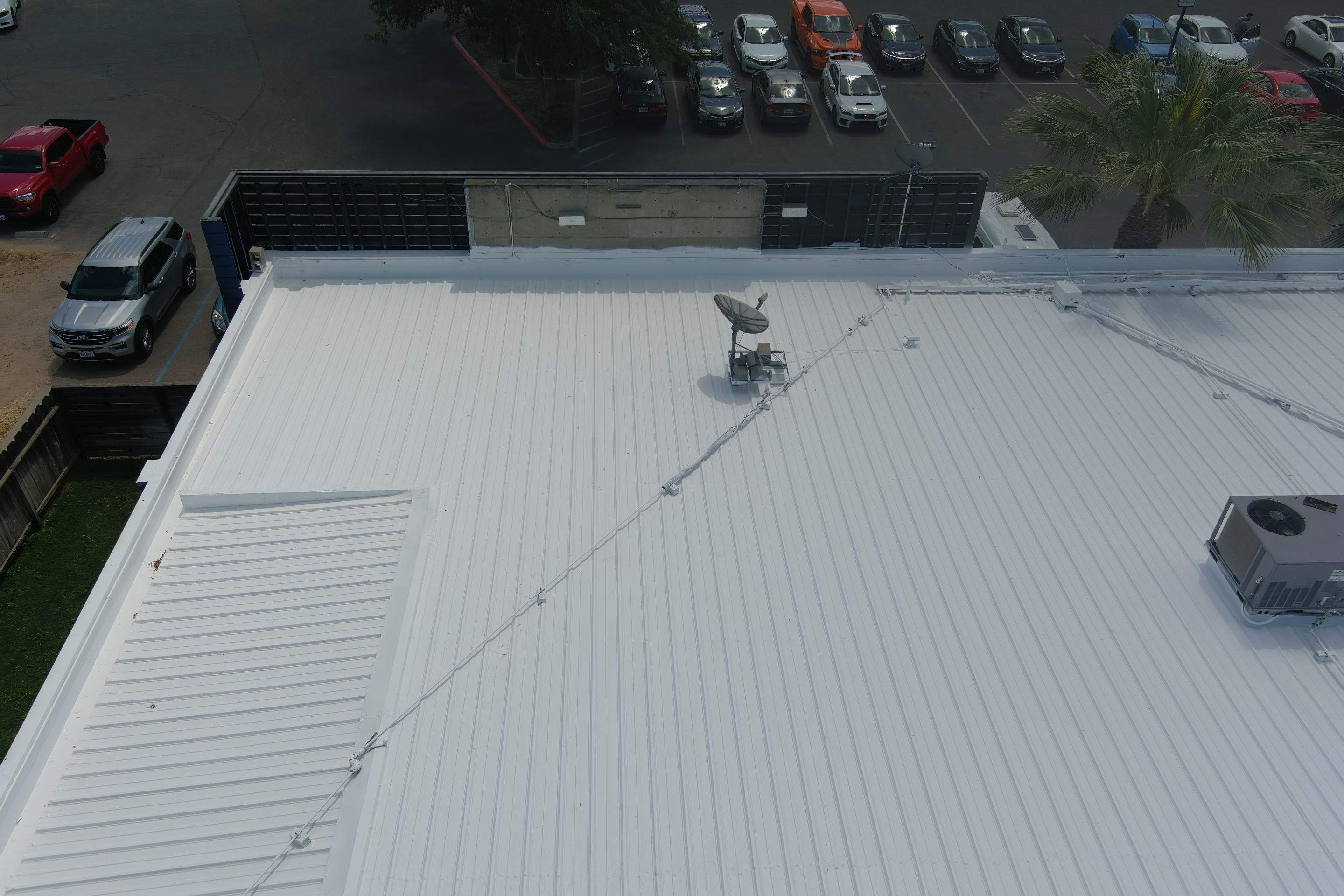 Metal roof restoration on commercial roof using Conklin Benchmark/ PUMA XL acrylic coatings over metal and foam by Straight Edge Roofing Inc