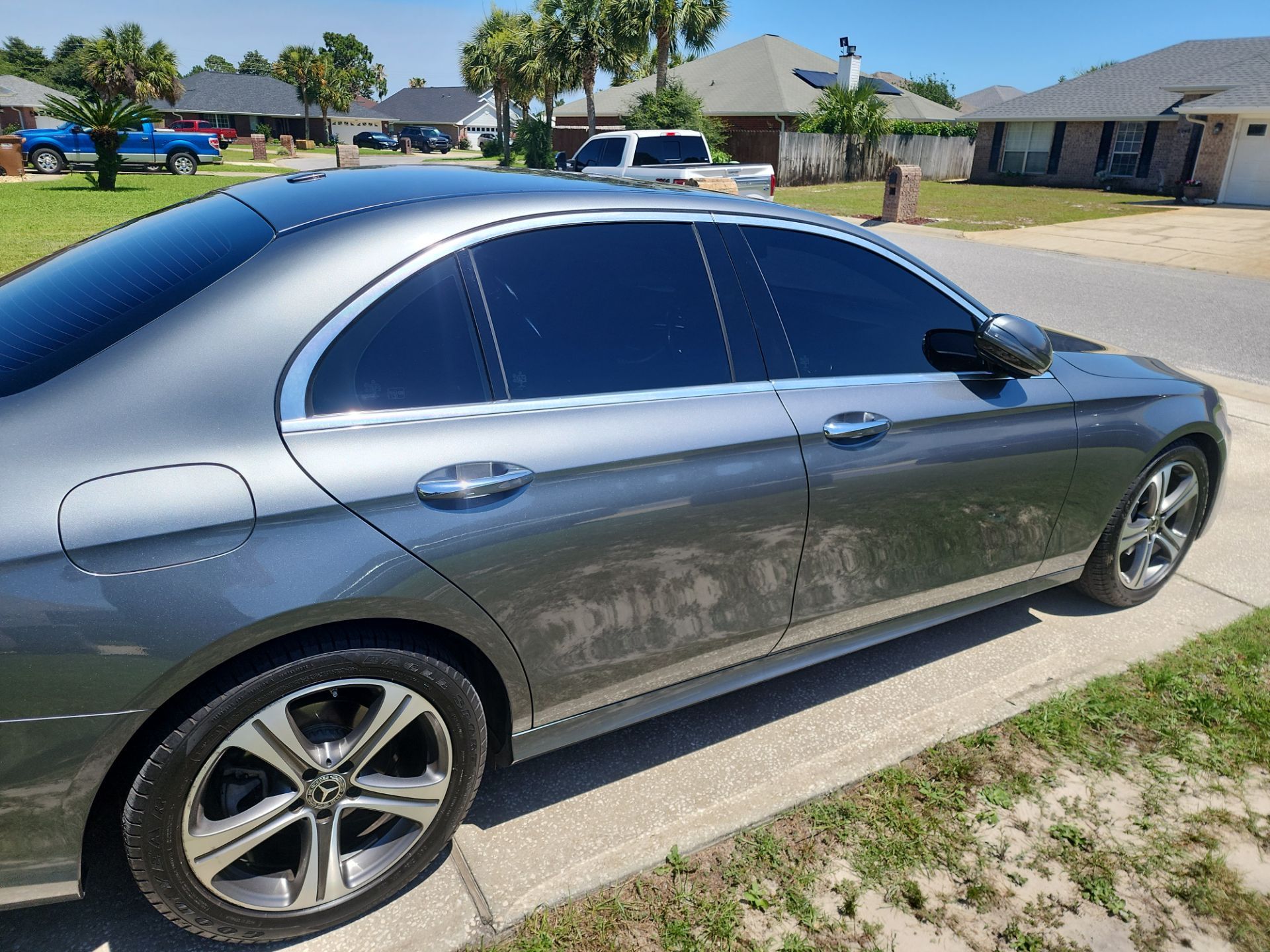the car shown in the photo has had its windows tinted this is a service provided by window tinting companies such as t's window tinting based in pensacola florida the tint appears to be applied uniformly across all the windows which helps in reducing glare blocking uv radiation improving privacy and enhancing the aesthetic appeal of the vehicle