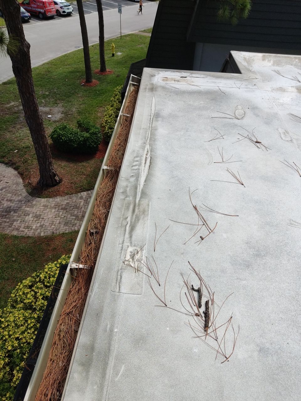 Commercial gutter cleaning West Palm Beach, FL	 before photo with filled gutters