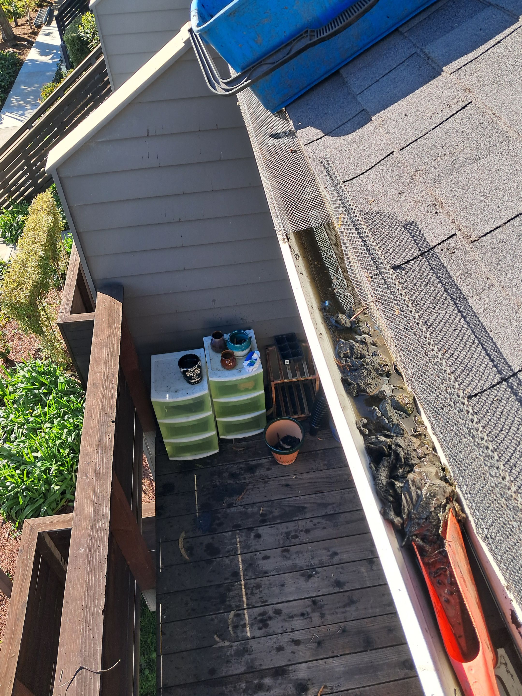HOA gutter cleaning in Santa Cruz ,before photo showing full gutters.