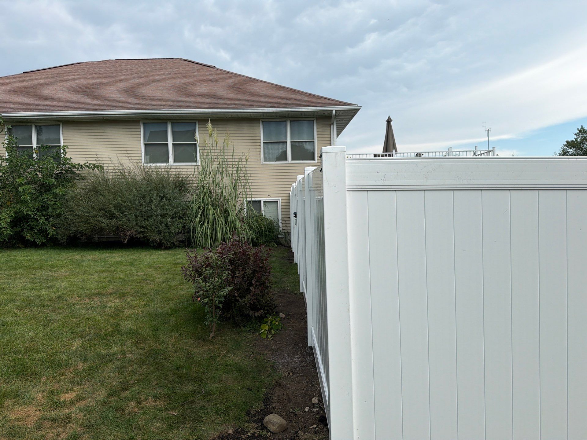 White Vinyl Privacy Fence Installation in Raymond, IA by Perfect Picket Fence and Stain