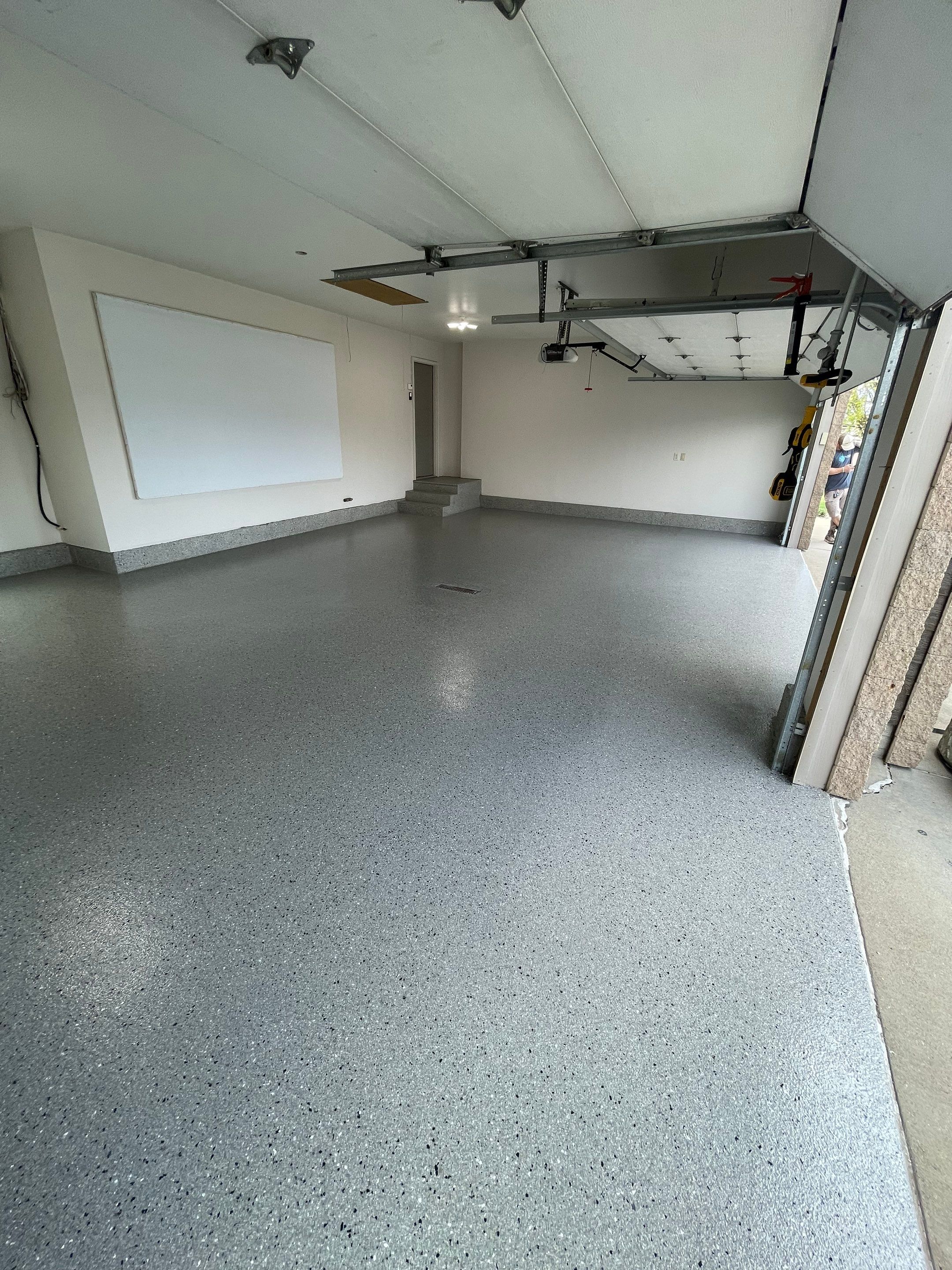 Residential Garage Floor Coating with Grey Speckled Epoxy Finish by Select Painting, Coatings & Garage Cabinets