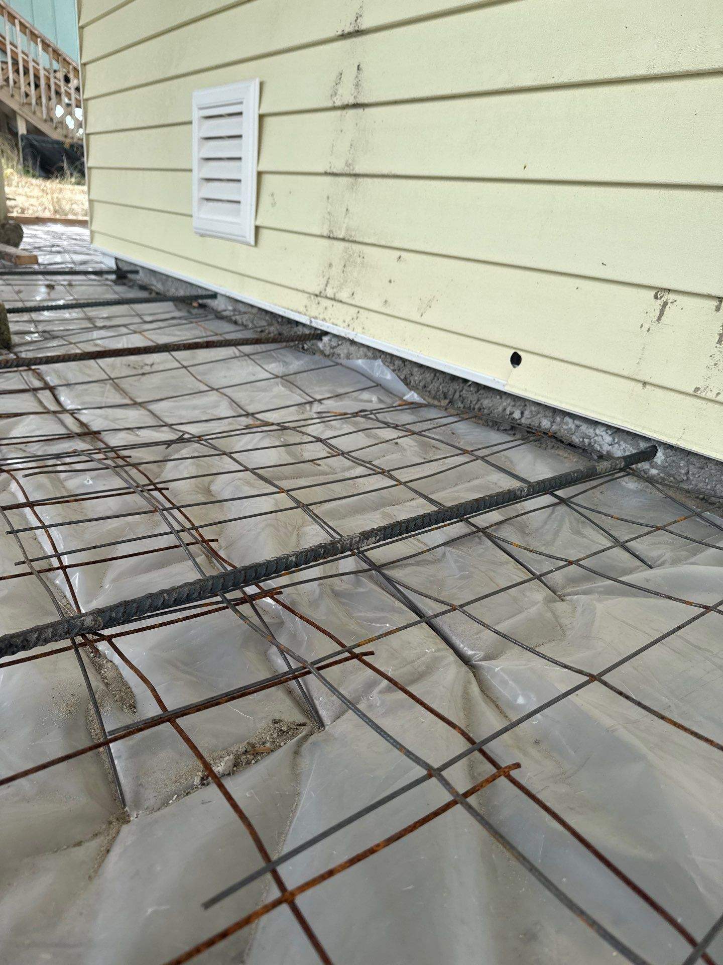 Concrete Slab Installation Beneath an Oak Island Home by RGR Construction and Roofing, LLC