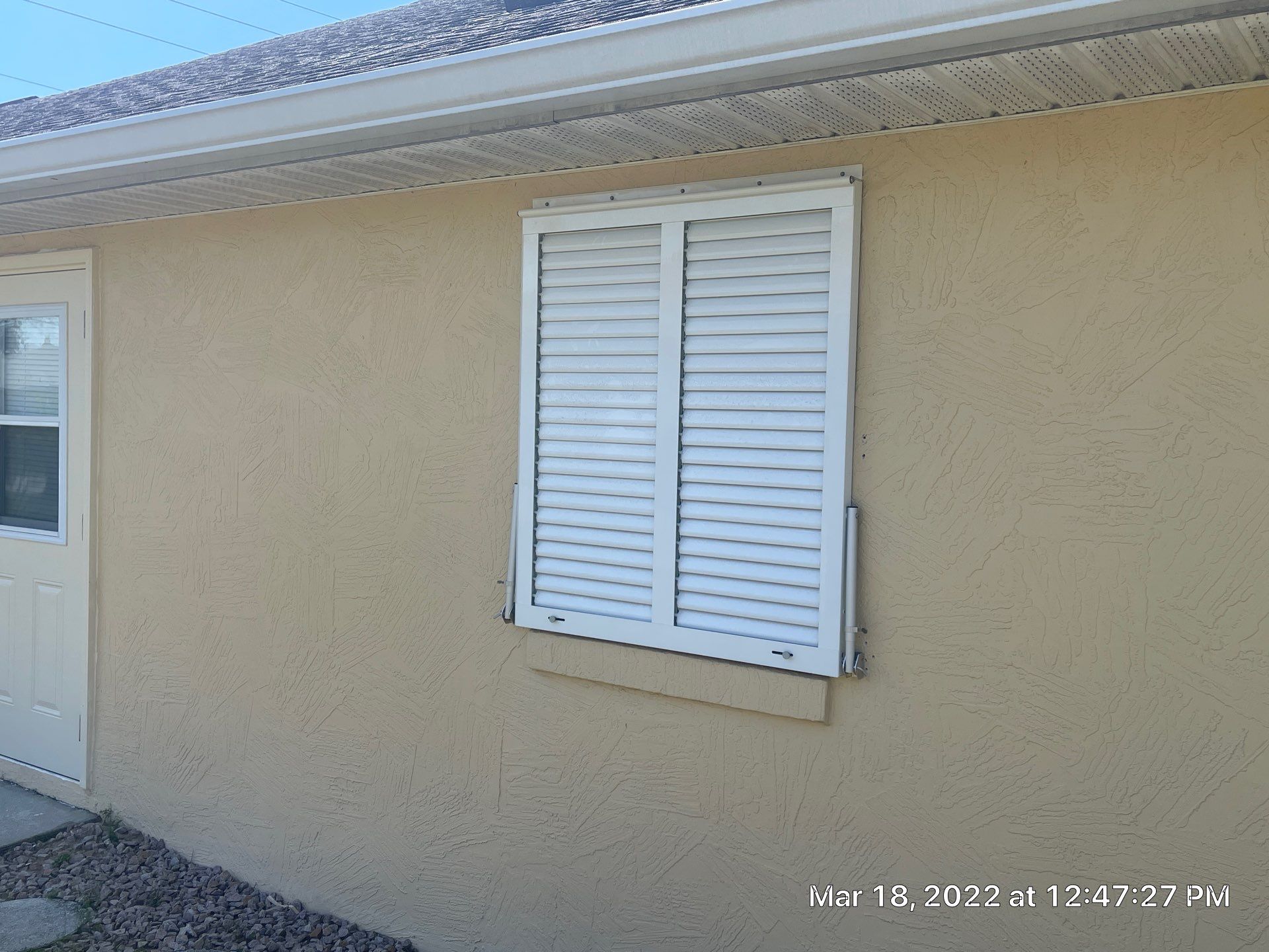 Bahama Shutters with front slide locking pin by Smart Guard Shutters