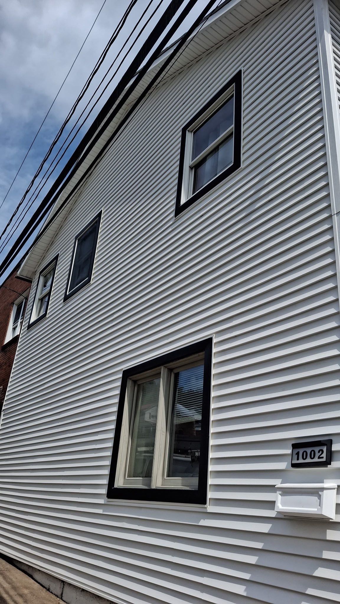 White siding  by Cousins Roofing Siding & Decks