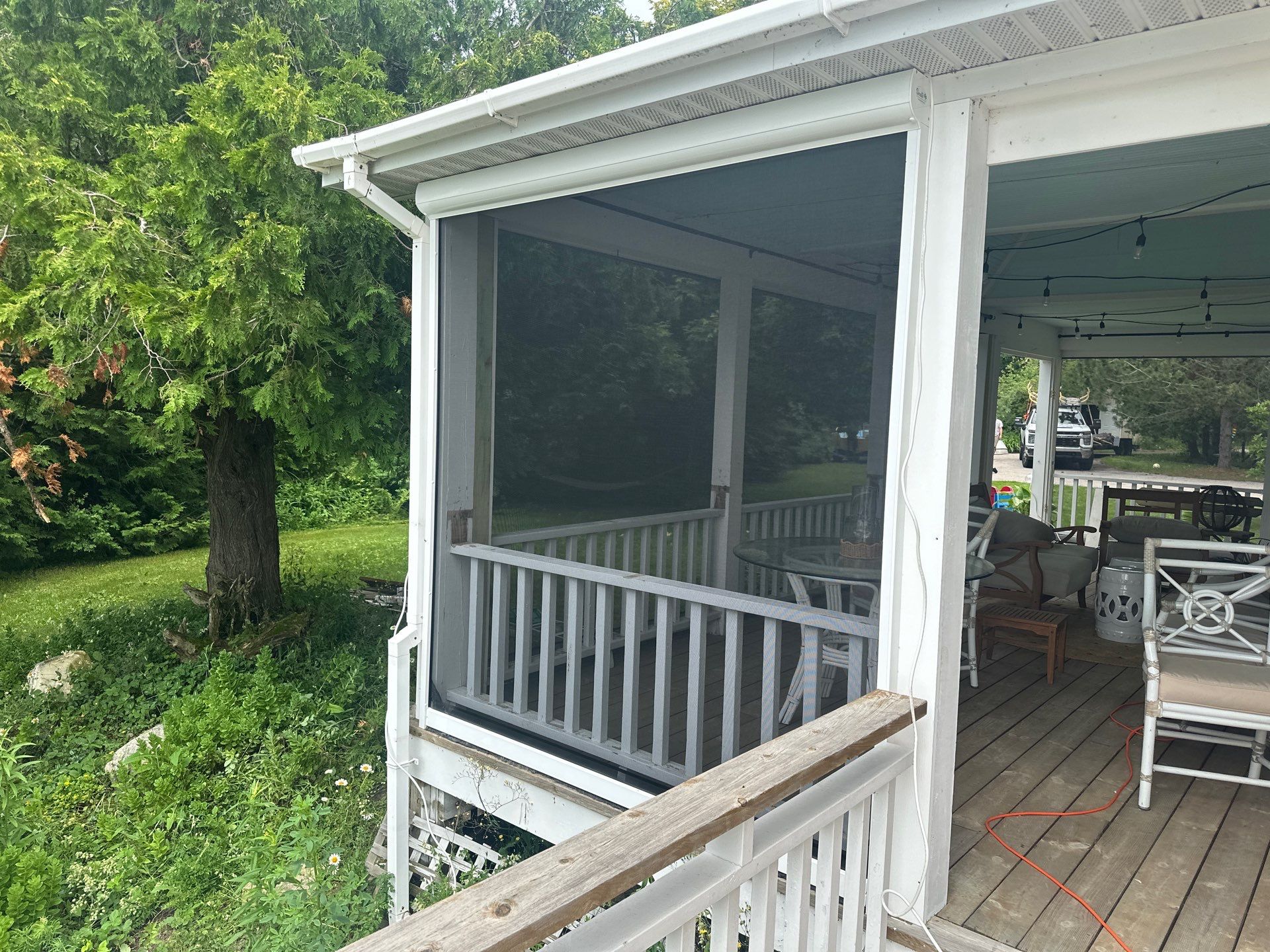 Sunesta motorized Sentry Privacy Screen Installation for Saint Ignace Waterfront Porch by Rainbow Seamless Systems