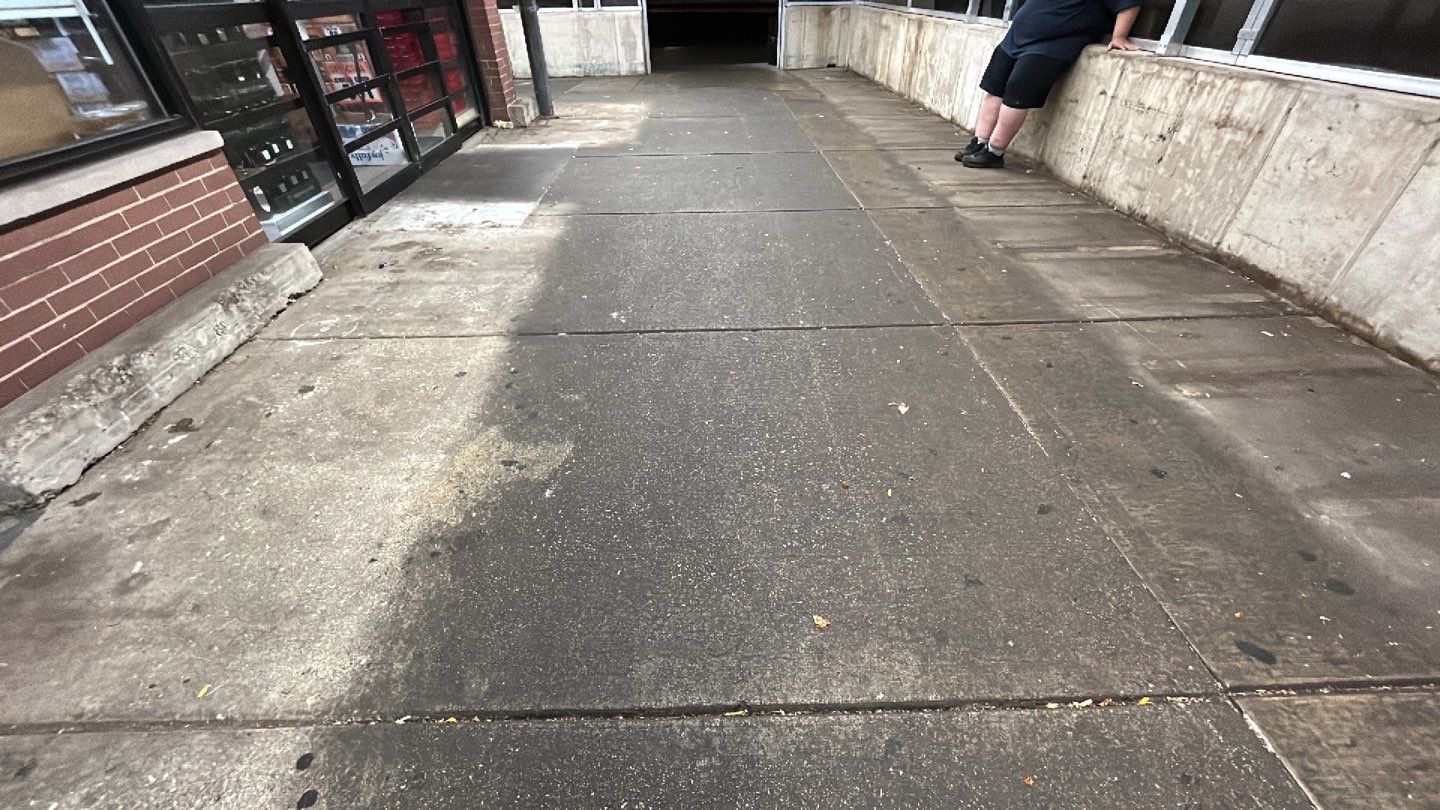 Concrete sidewalk cleaning and degreasing by Northern Power Washing LLC.