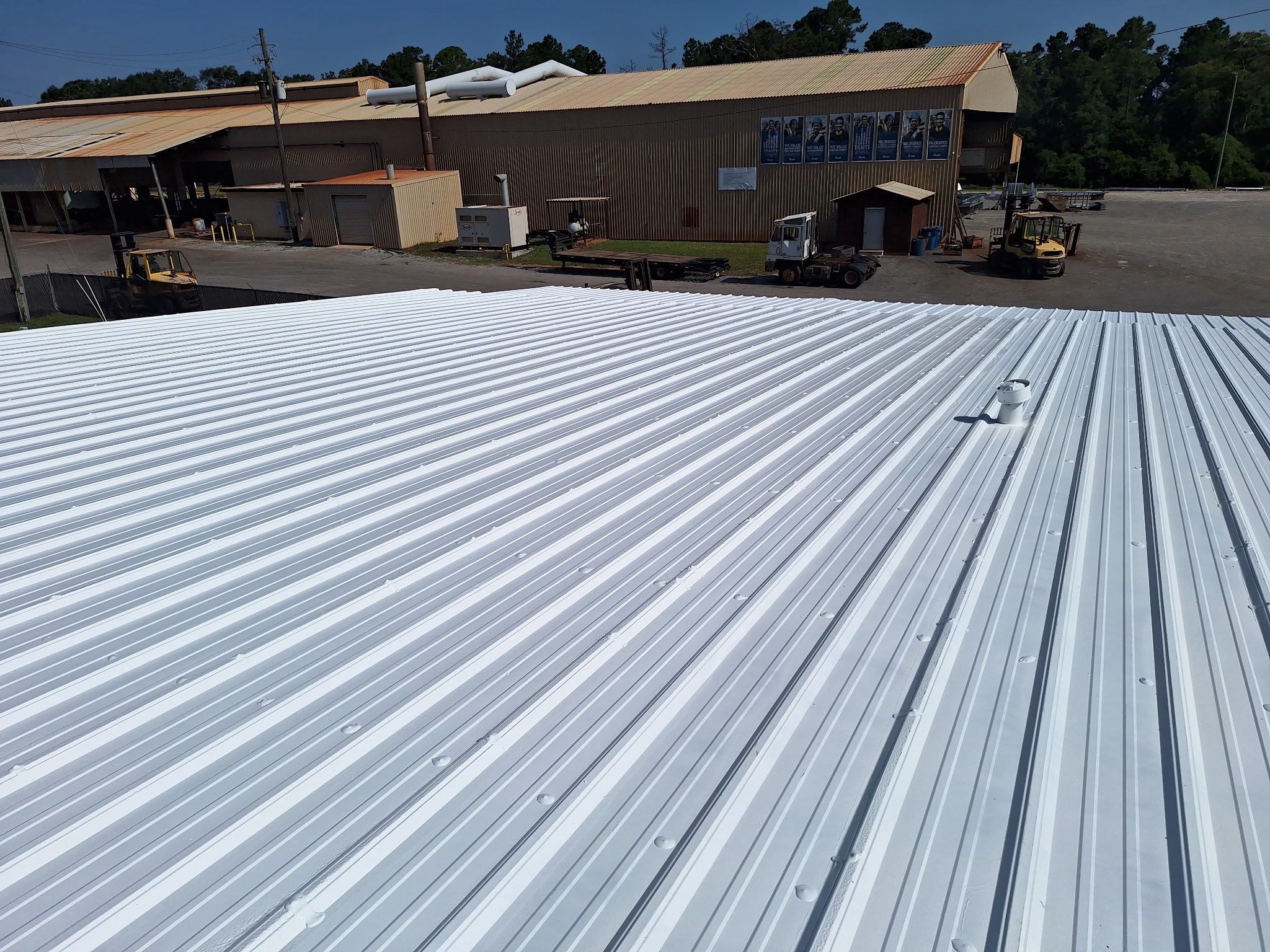 Commercial Metal Roof Restoration with White Protective Coating by Southern Roof Solutions