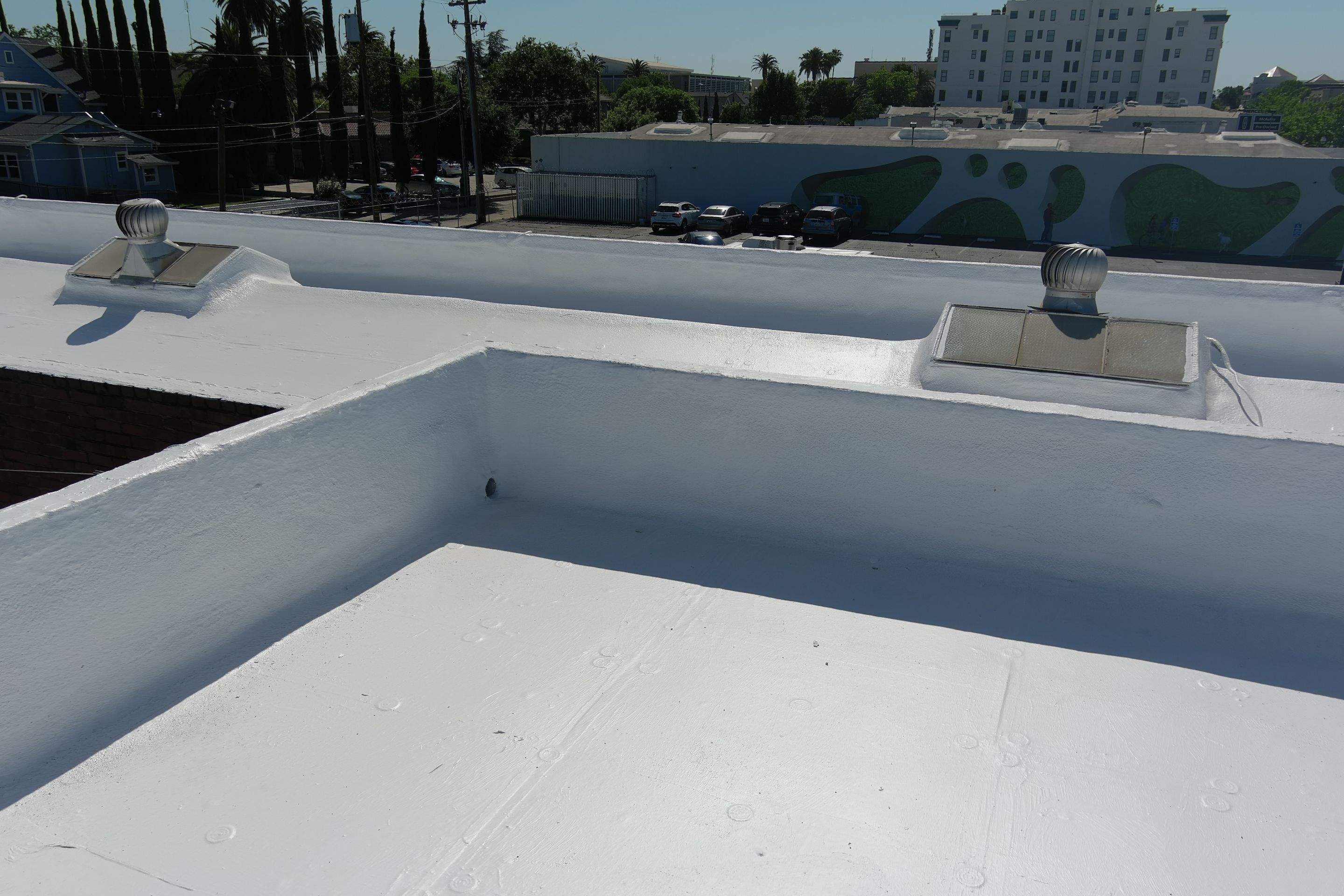 Commercial Roofing Installation using Conklin BenchPly system with PUMA top coat (imbedded fabric system) by Straight Edge Roofing Inc