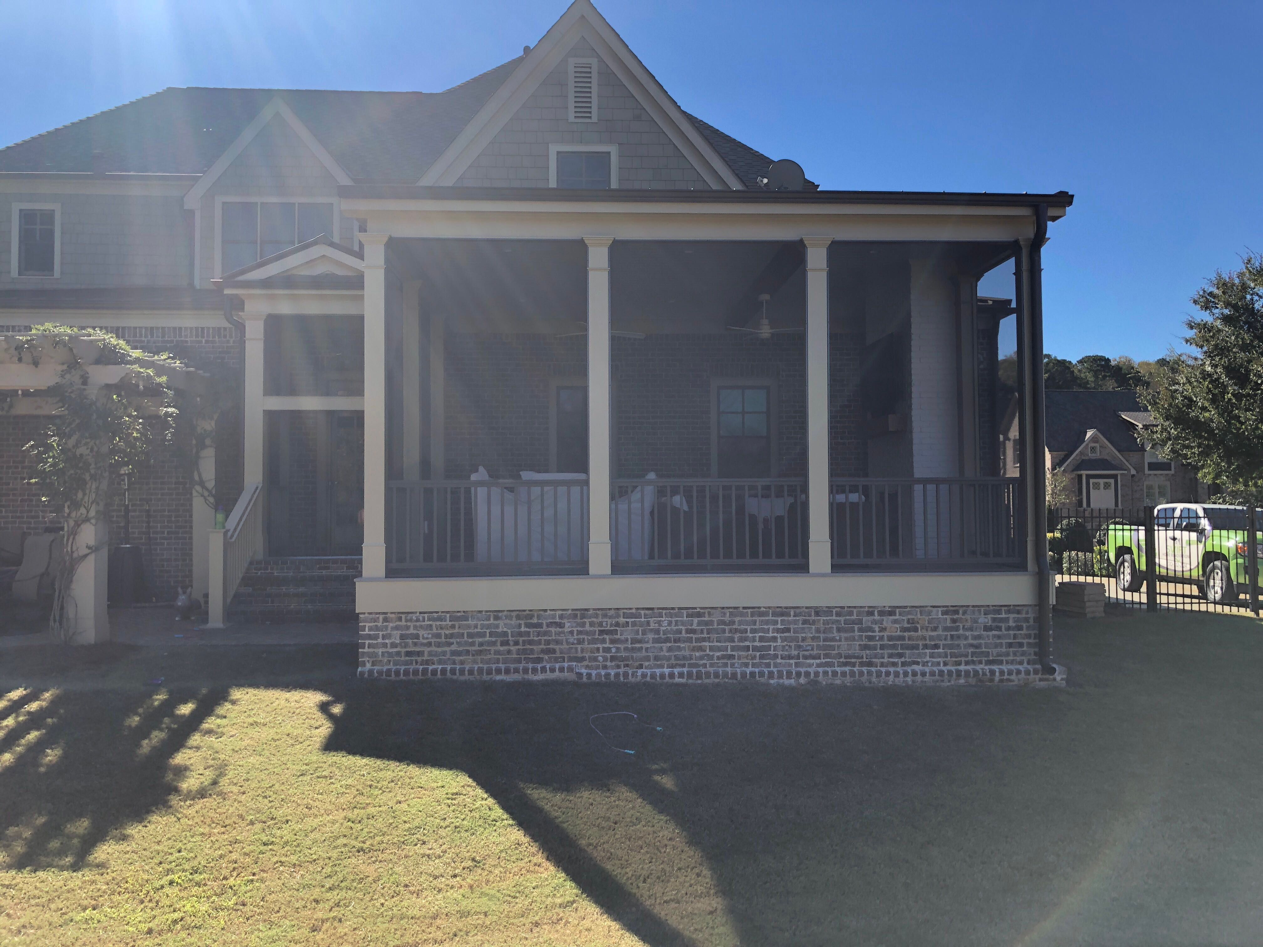 Custom Screened Porch Addition with White Brick Fireplace in Duluth by Swift Home Renovations