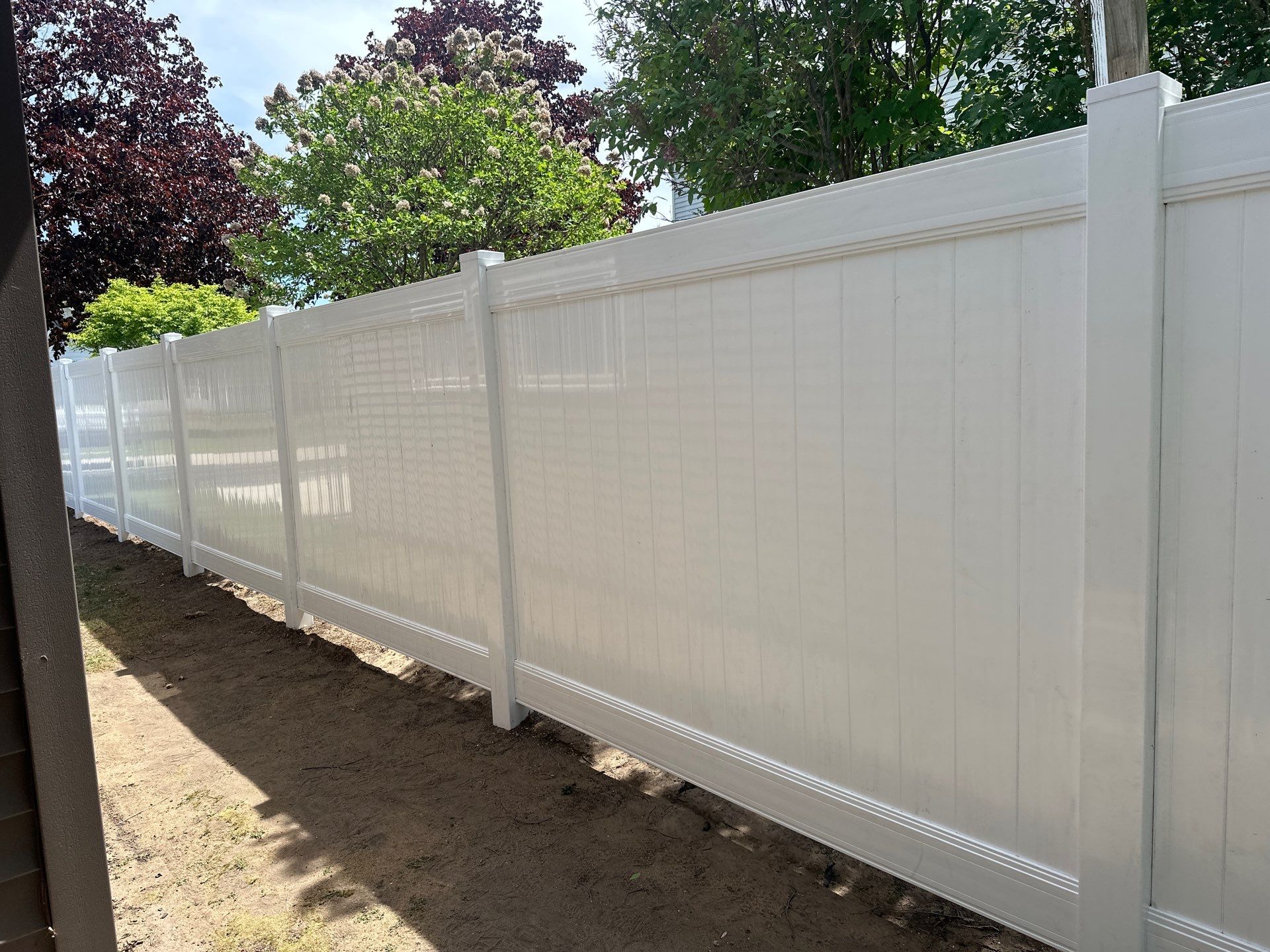 White Vinyl Privacy Fence Installation in Lawler, IA by Perfect Picket Fence and Stain