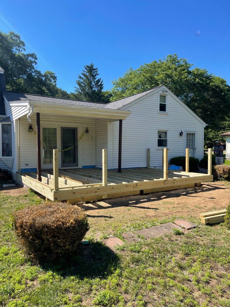 New deck using Trex Tropical Lava rock, Transcend railings in Vintage Lantern with matching fascia. by DiGiorgi Roofing and Siding Inc