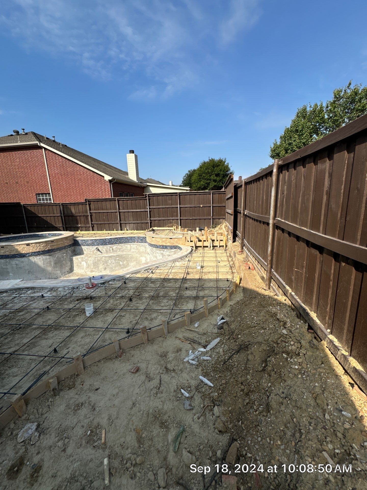 Freeform Pool and Spa with Raised Stone Water Wall by Pinnacle Pools and Spas - DFW