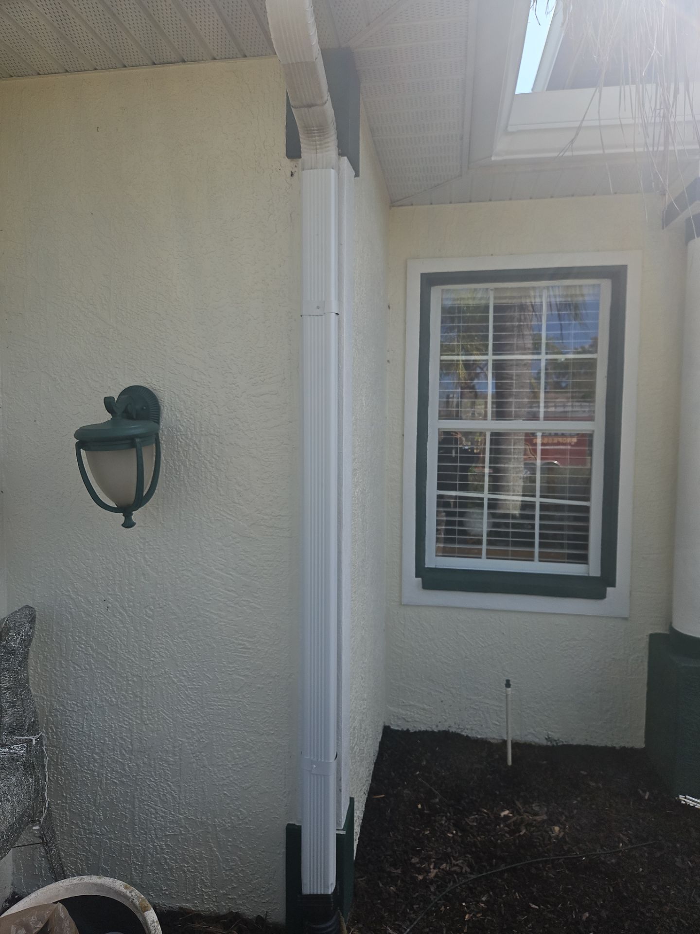 White seamless Gutters and downspout repair in Sarasota FL by Gutter Professors
