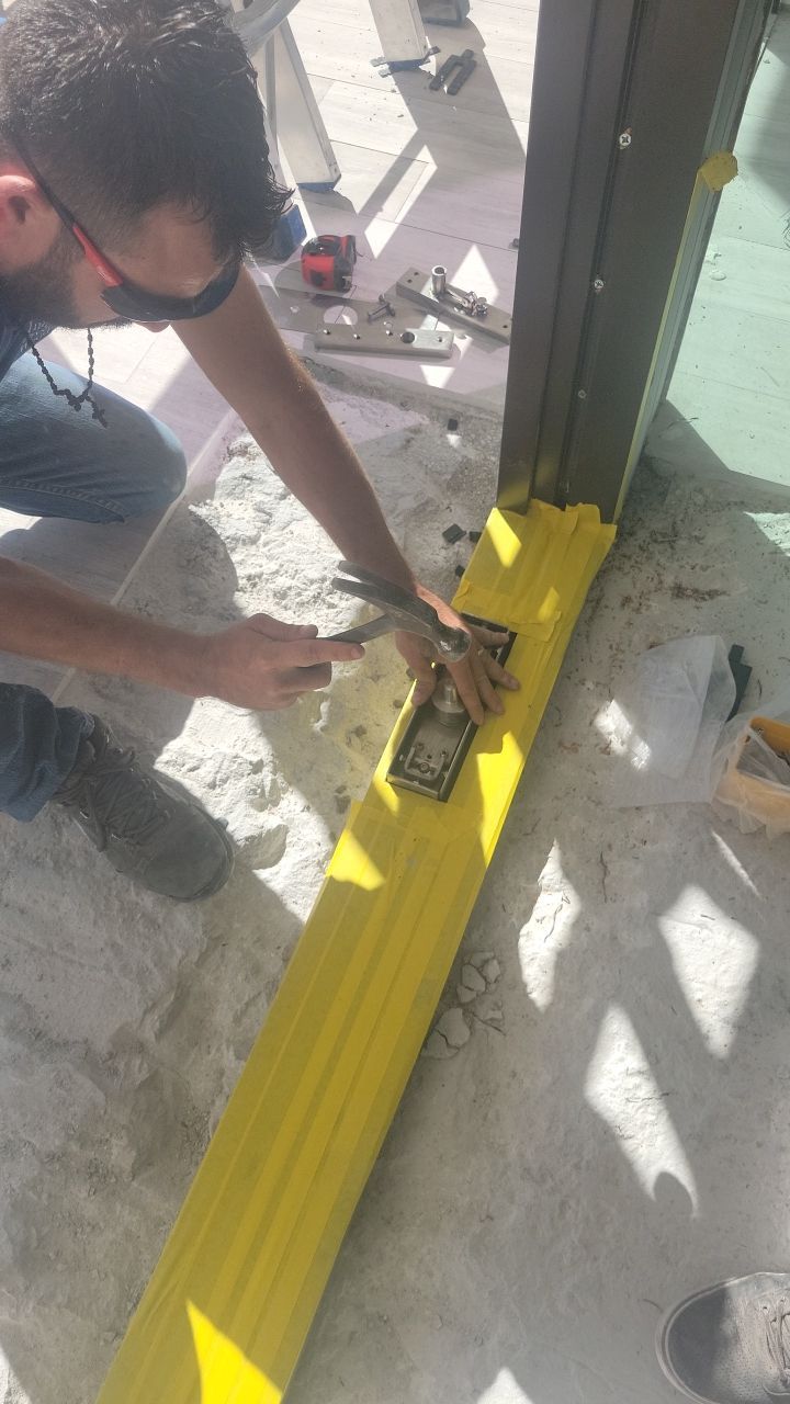 Custom Material Pivot Door installation by Impact Precious Wood Inc.