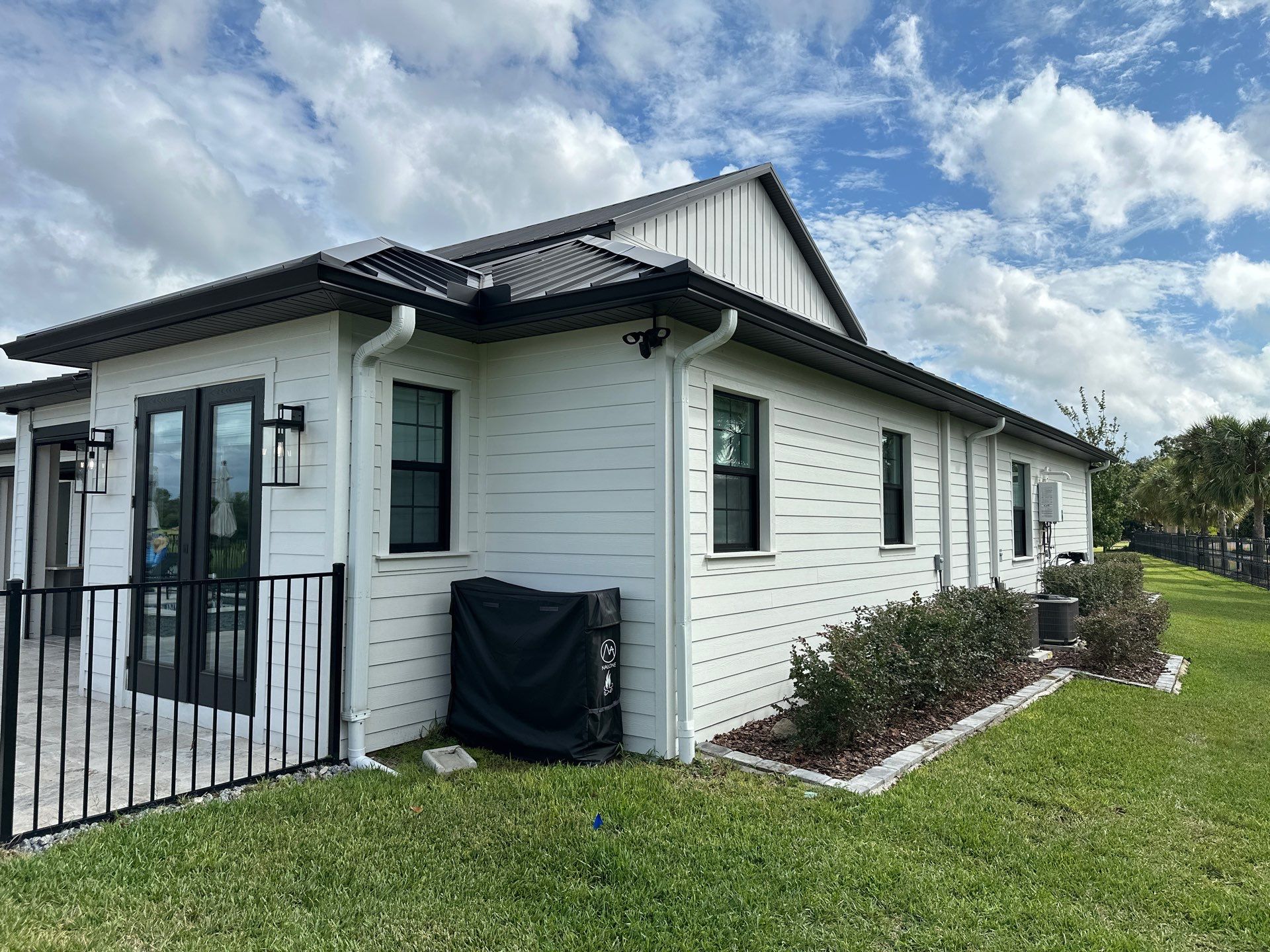Complete Two-Story House Wash and Driveway Cleaning in Winding River Community, Bradenton, FL by Sunshine AquaWash