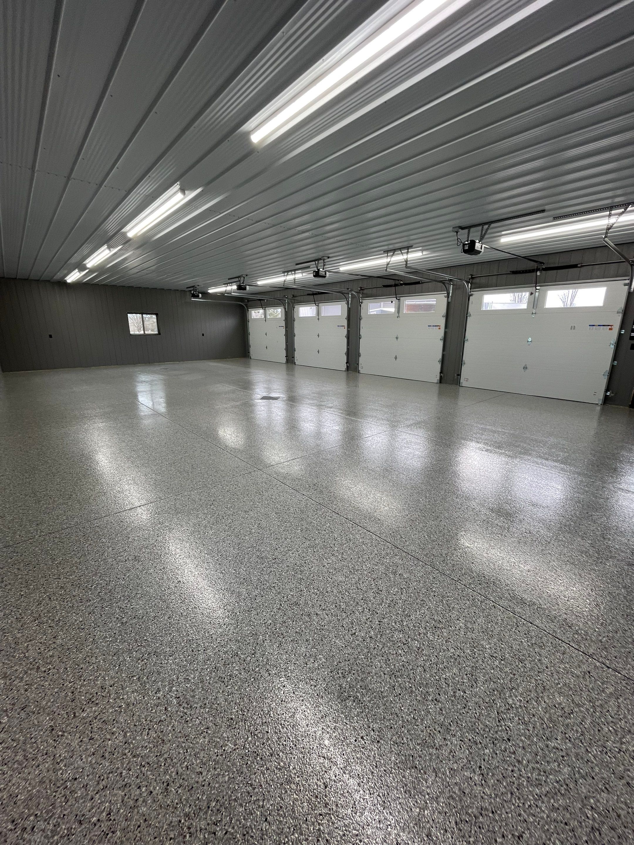 Speckled Epoxy Floor Coating for Large Shop in Rock Valley by Select Painting, Coatings & Garage Cabinets