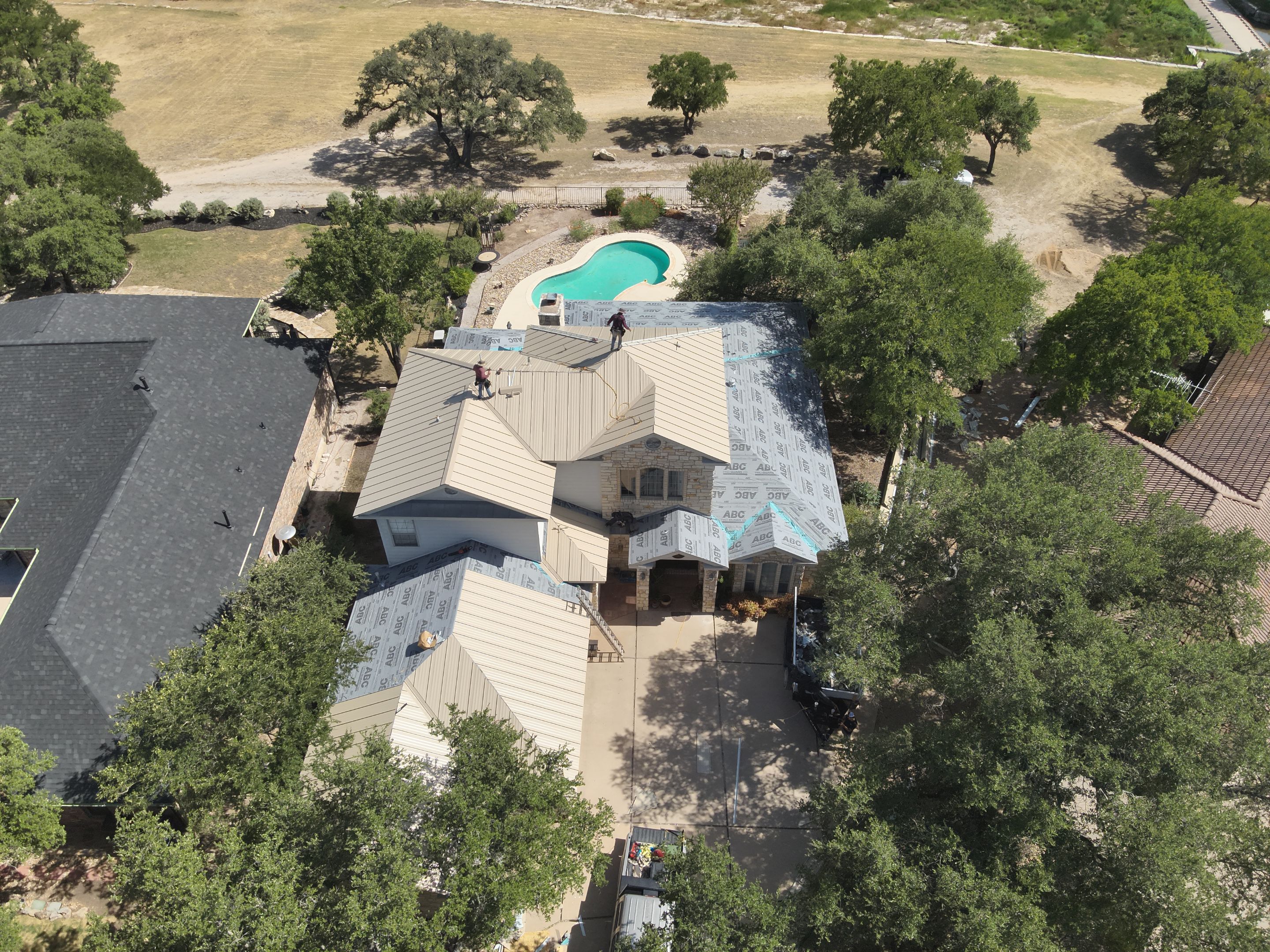 Residential Roof Replacement using 24 GA Double-Lock - Surrey Beige by Action Exteriors Austin