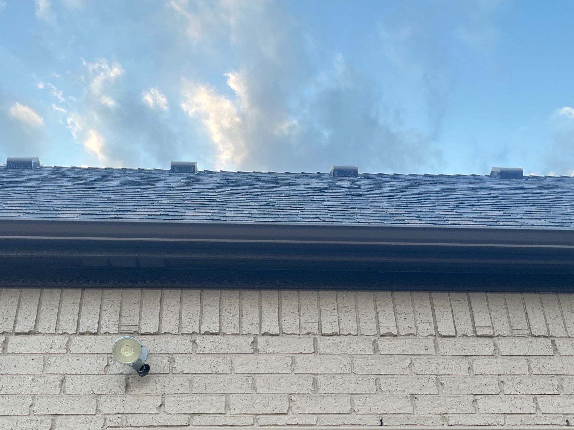 Cream brick/mixed stone with IKO Shadow Brown by Tejas Roofworks + Restoration