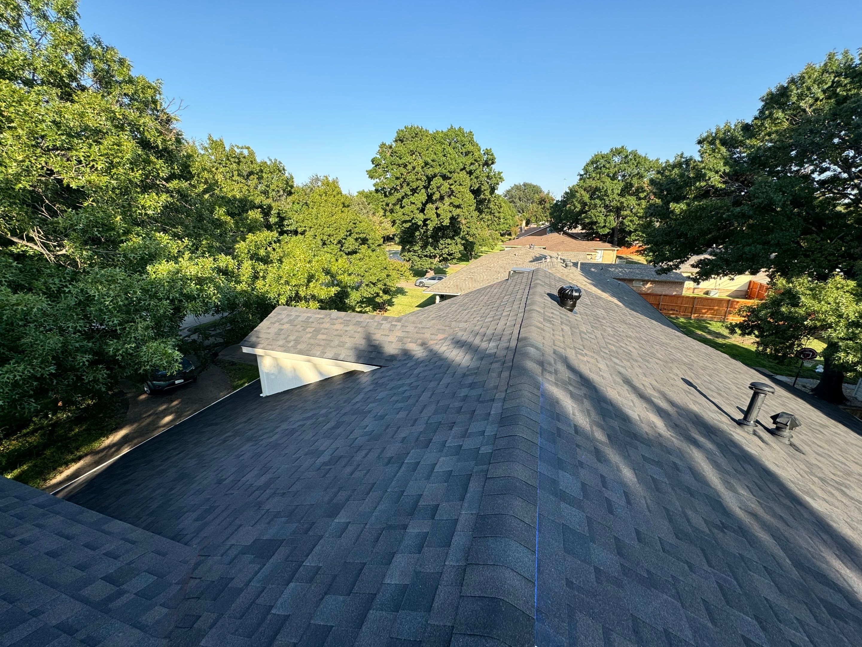 IKO Glacier-White brick house by Tejas Roofworks + Restoration