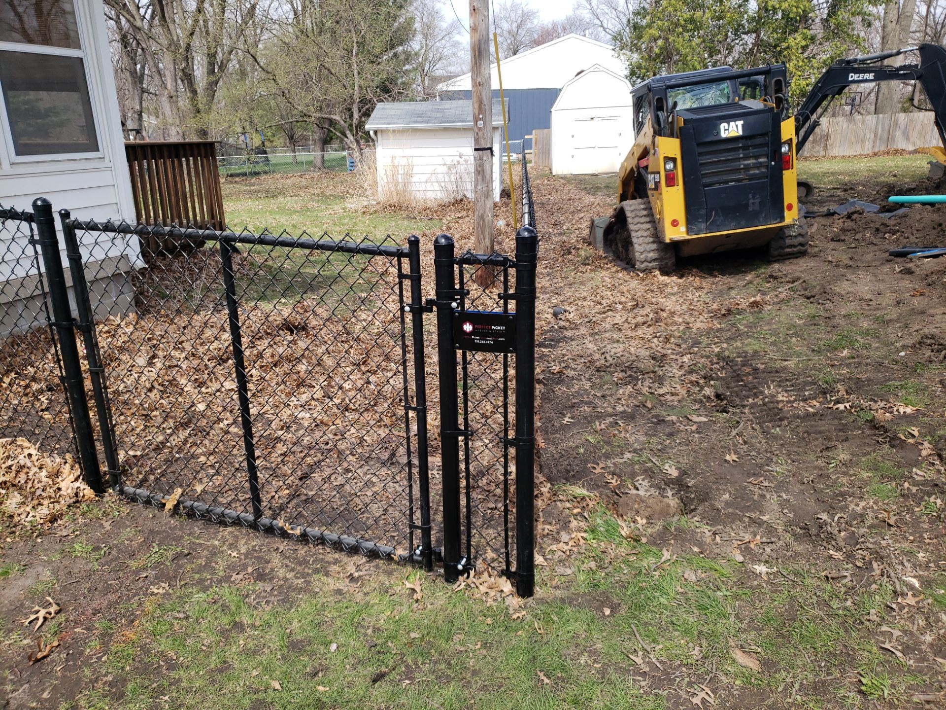 Black Vinyl-Coated Chain Link Fence Installation in Cedar Falls by Perfect Picket Fence and Stain