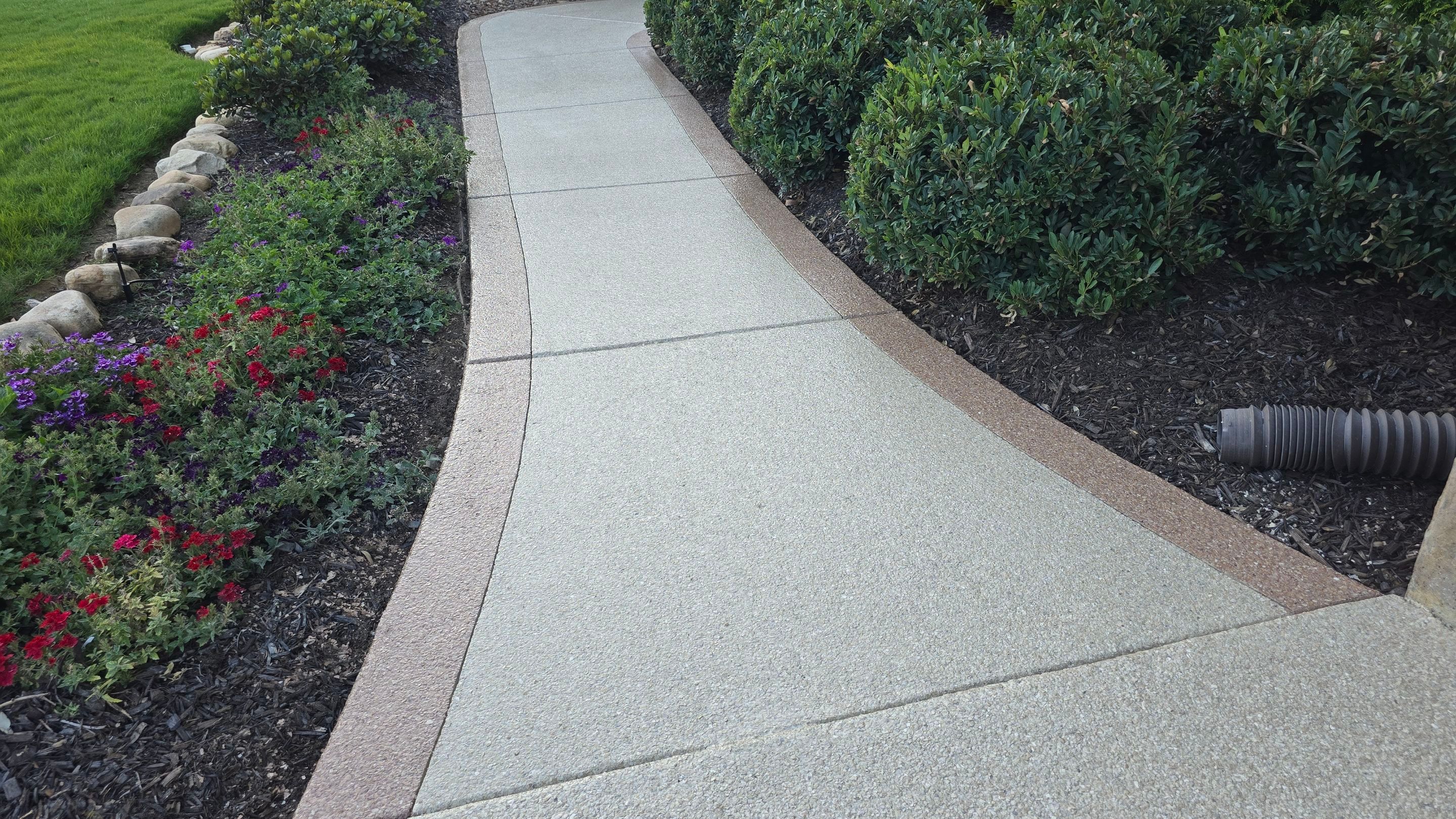 Driveway and sidewalk using Feldspar with the border done in Spilite by Elite Floor Solutions
