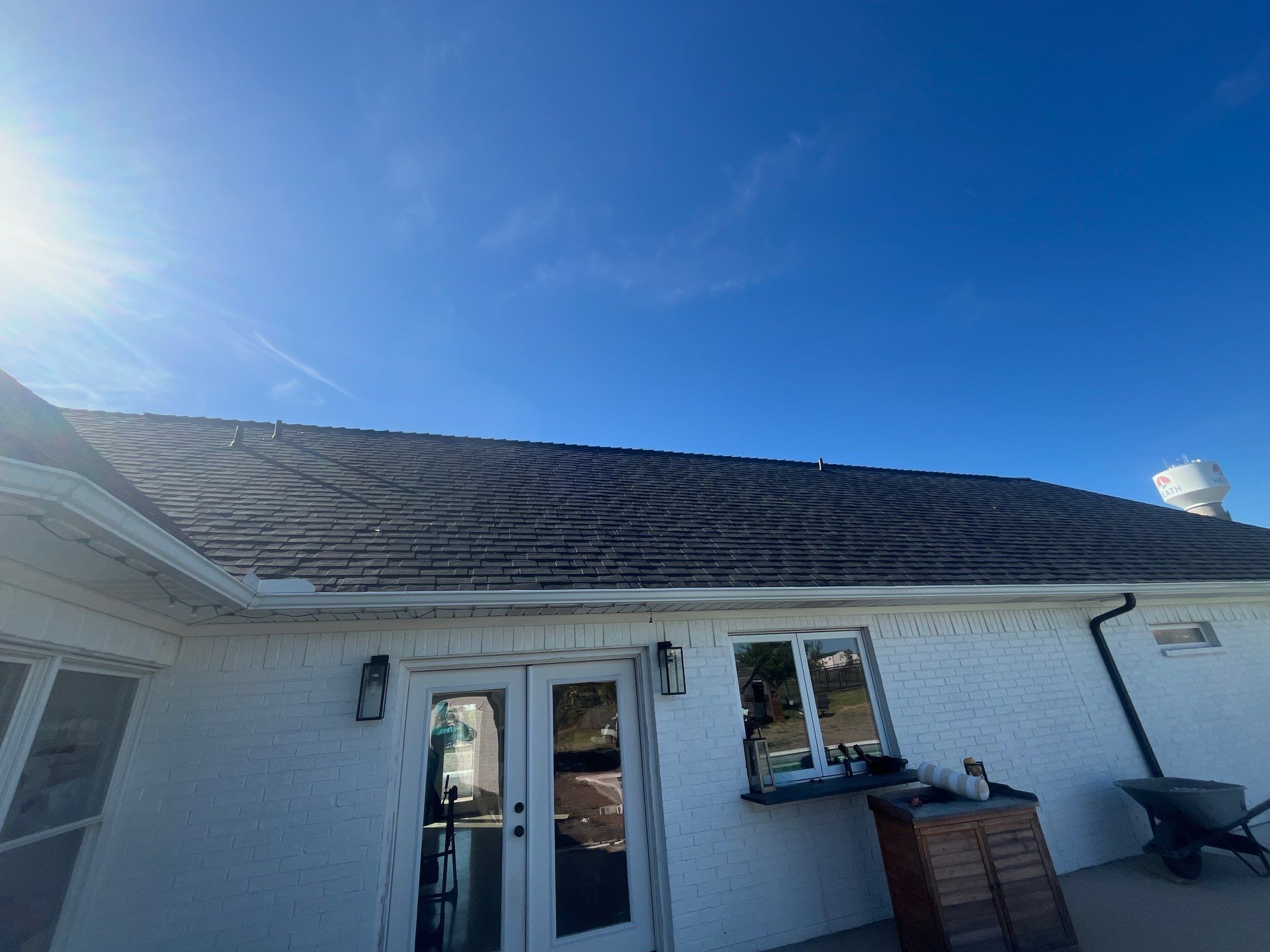 White brick with Malarkey Brilliant Black by Tejas Roofworks + Restoration