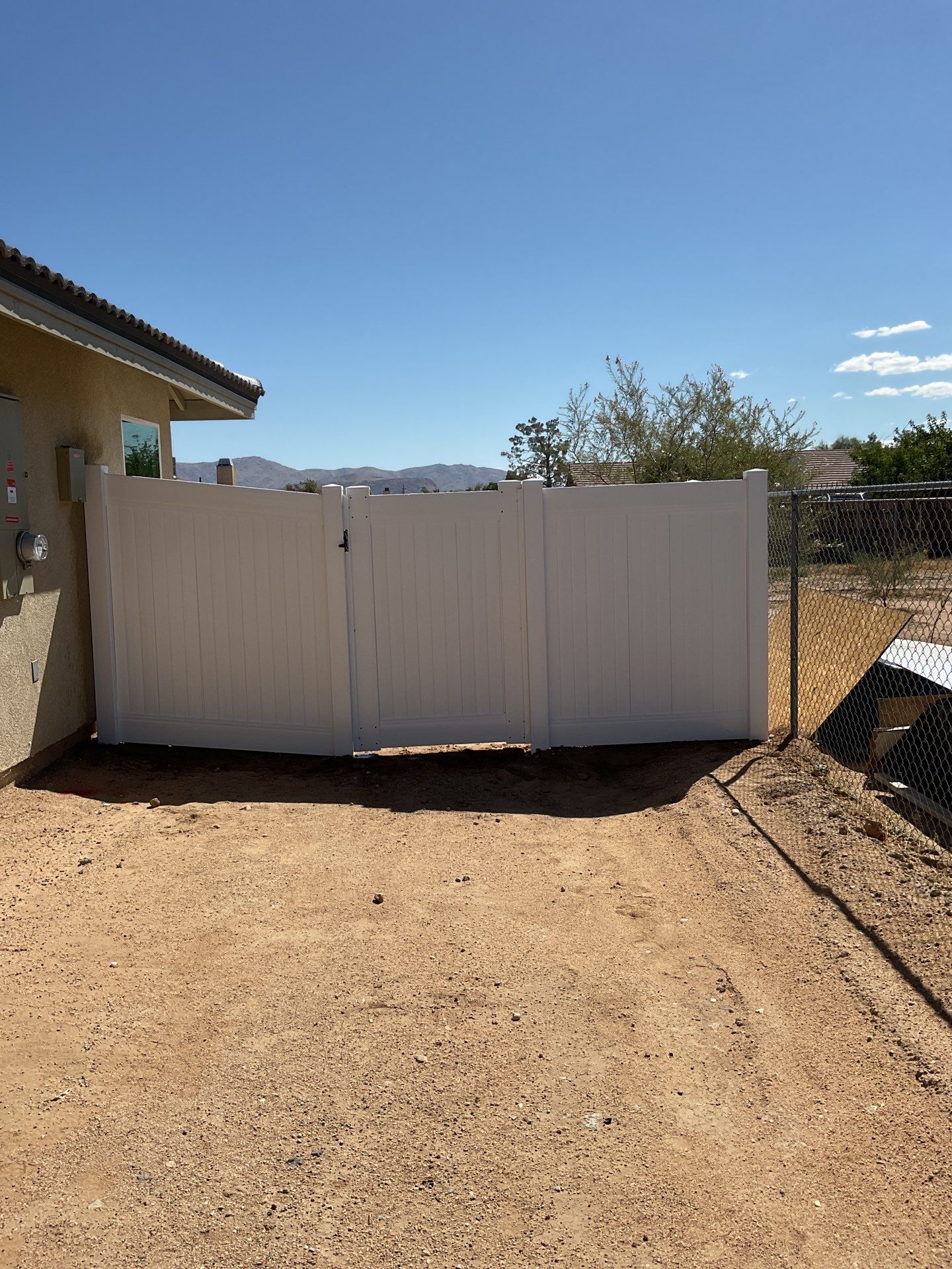 6ft White Privacy Vinyl Fence with Chain-link Fence by Fence Guys Inc.