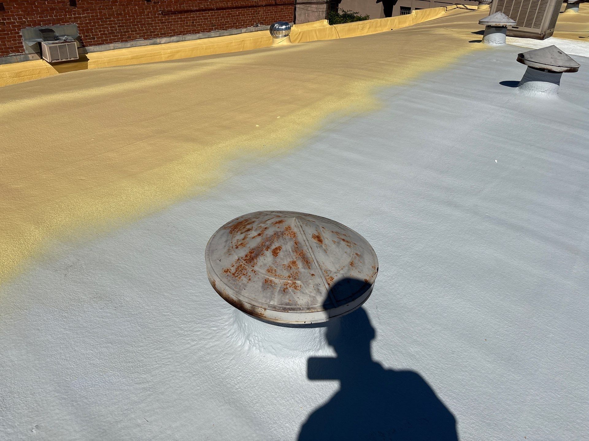 Foam and coatings on commercial roof by Straight Edge Roofing Inc