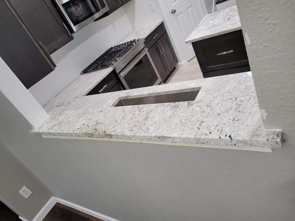Kitchen countertops using Salinas White Granite  by Mena stone surfaces