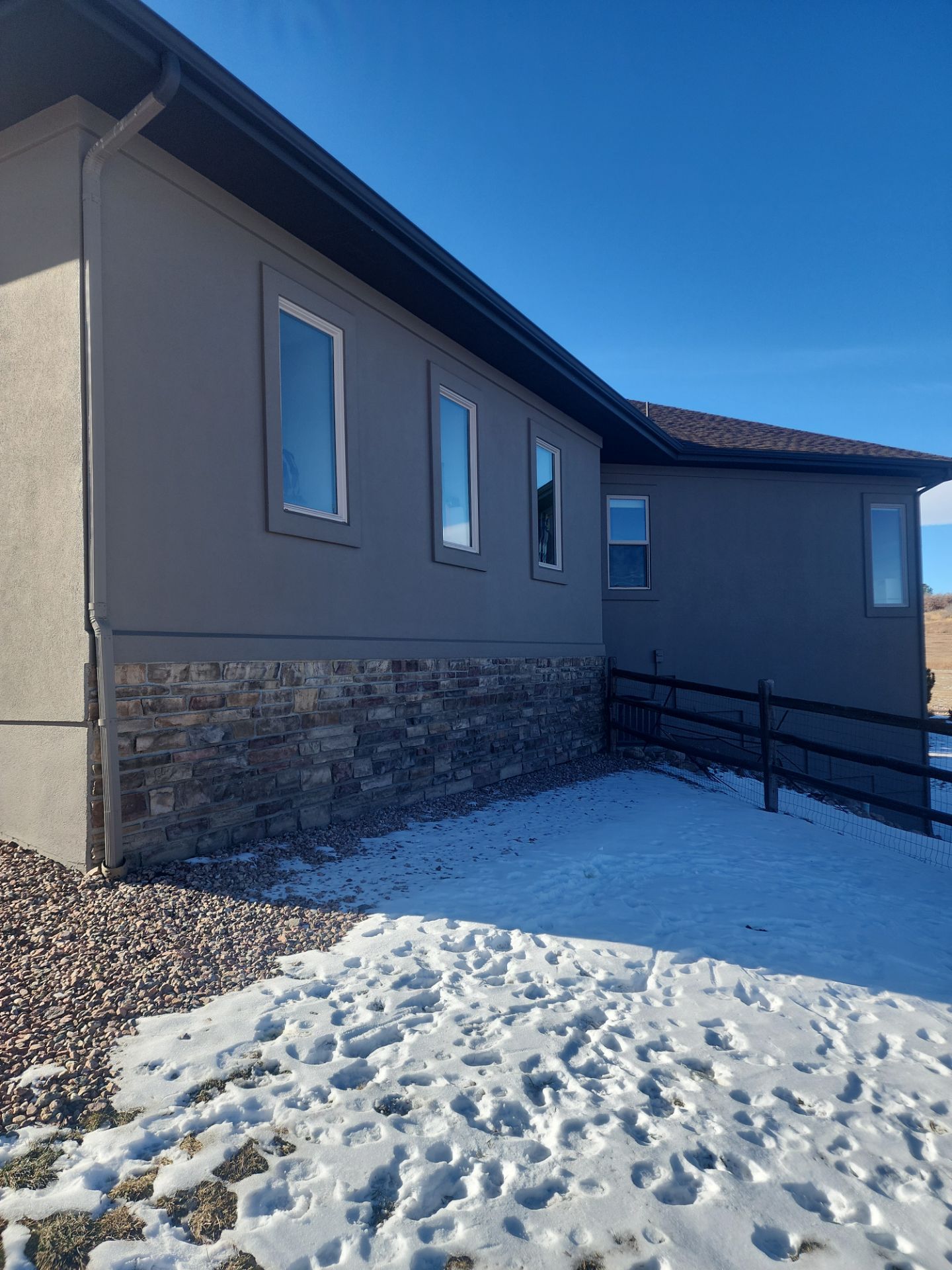 Castle Rock Elegance: White Stucco Exterior with Bold Tricorn Black by J&M Painting LLC