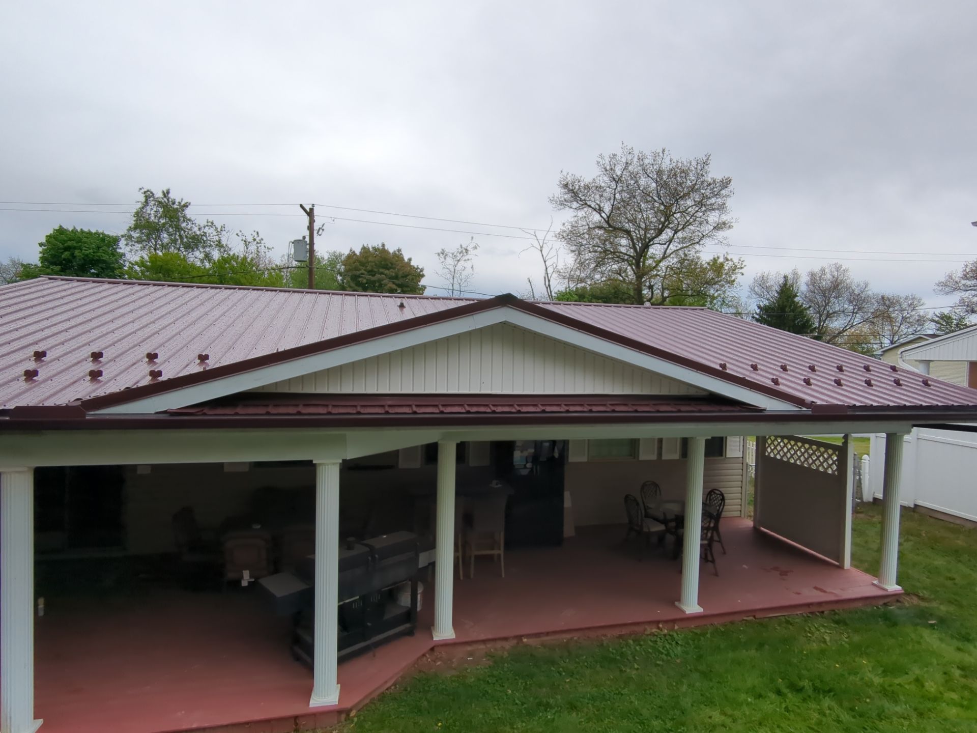 Maroon ABM Metal Roof Replacement and Gutter Installation in Shenandoah by Esh Builders