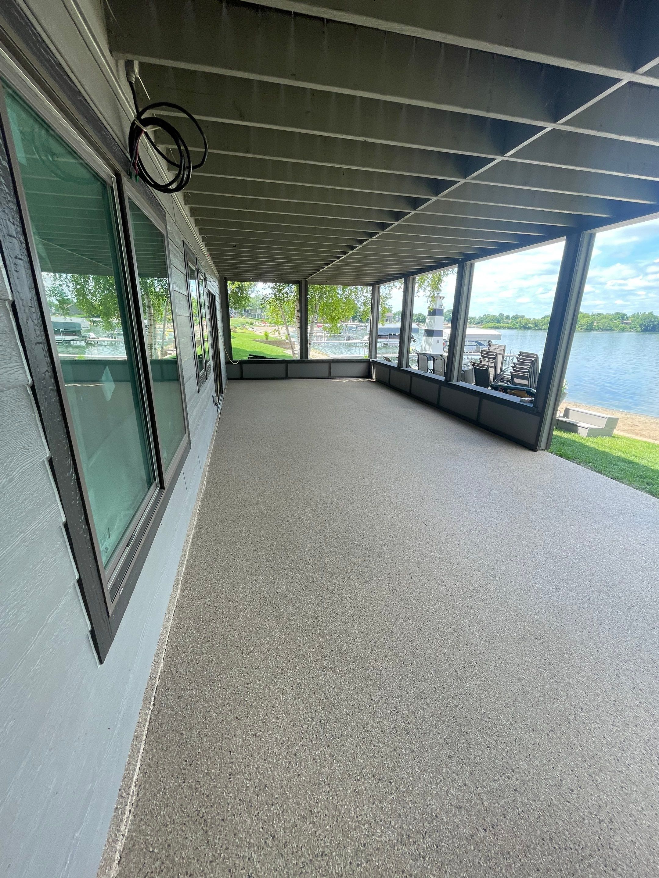 Lakefront Screened Patio Concrete Coating Installation in Wentworth by Select Painting, Coatings & Garage Cabinets
