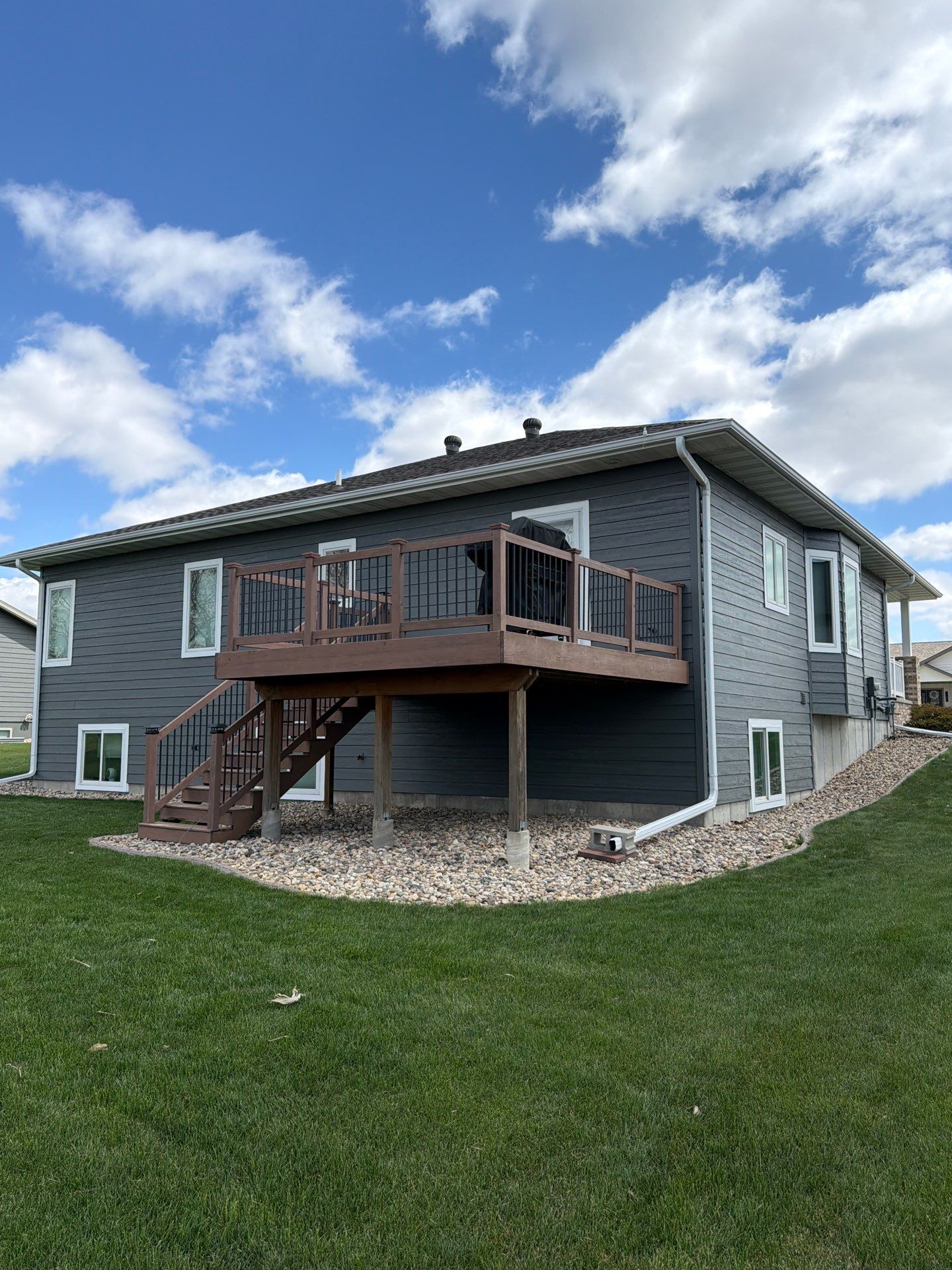 Madison Exterior Remodel with Dark Gray Siding and Stone Accents by Select Painting, Coatings & Garage Cabinets