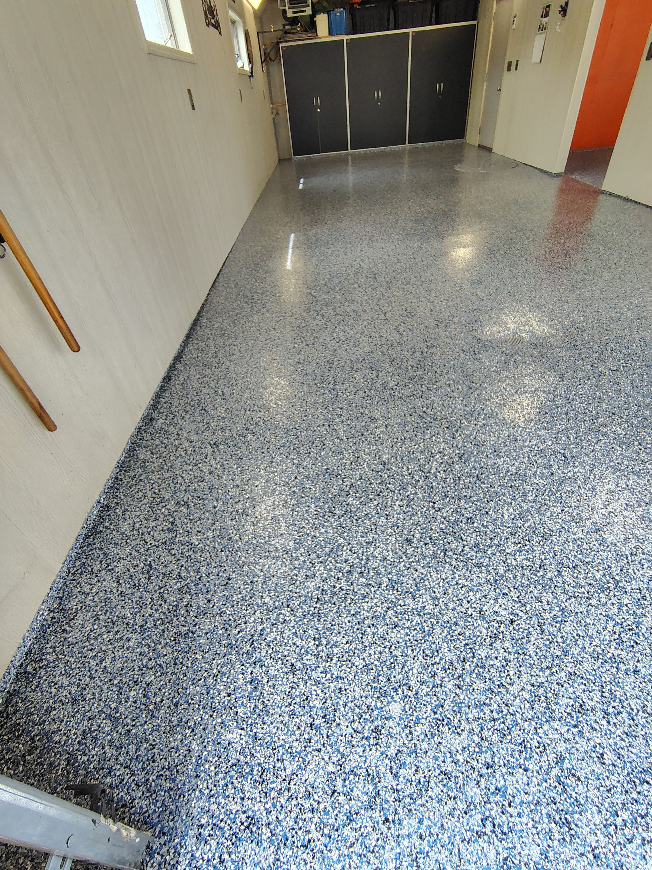 Custom Grey Flake Epoxy Garage Floor Installation in Remsen by Select Painting, Coatings & Garage Cabinets